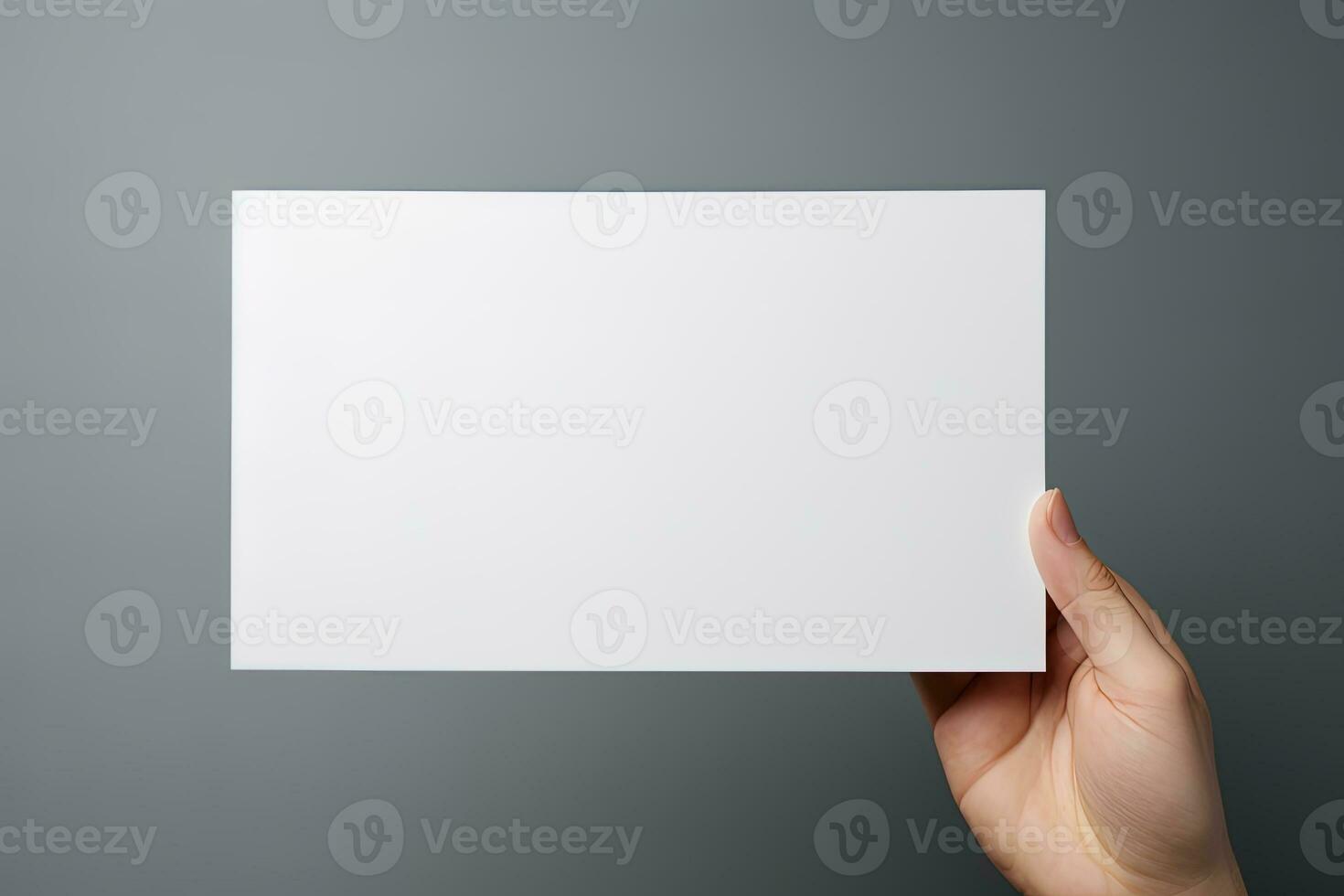 A human hand holding a blank sheet of white paper or card isolated on grey background. ai generated photo