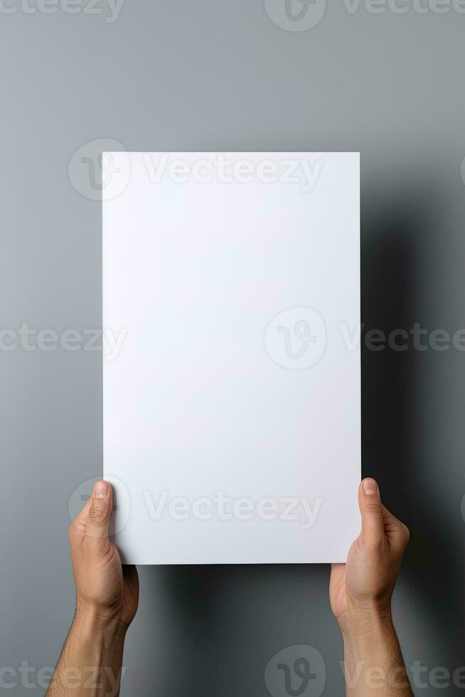 A human hand holding a blank sheet of white paper or card isolated on grey background. ai generated photo