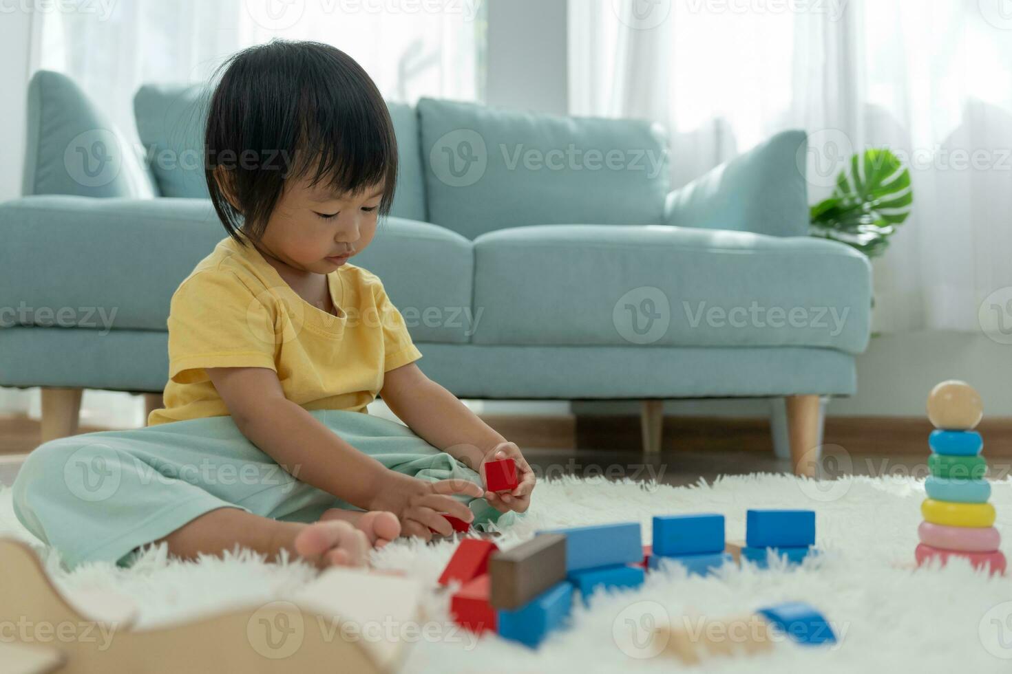 Happy Asian child playing and learning toy blocks. children are very happy and excited at home. child have a great time playing, activities, development, attention deficit hyperactivity disorder photo