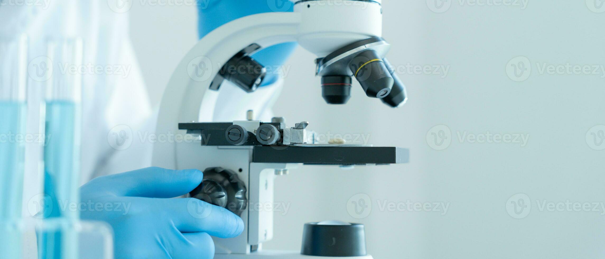 Scientist analyze biochemical samples in advanced scientific laboratory. Medical professional use microscope look microbiological developmental of viral. Biotechnology research in science lab. photo