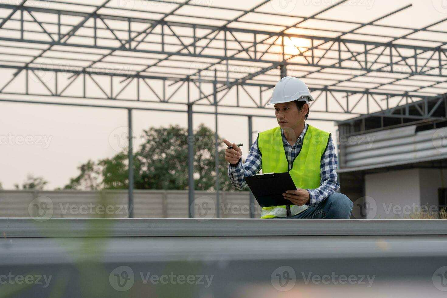 inspector or engineer is inspecting construction and quality assurance new house using a checklist. Engineers or architects or contactor work to build the house before handing it over to the homeowner photo