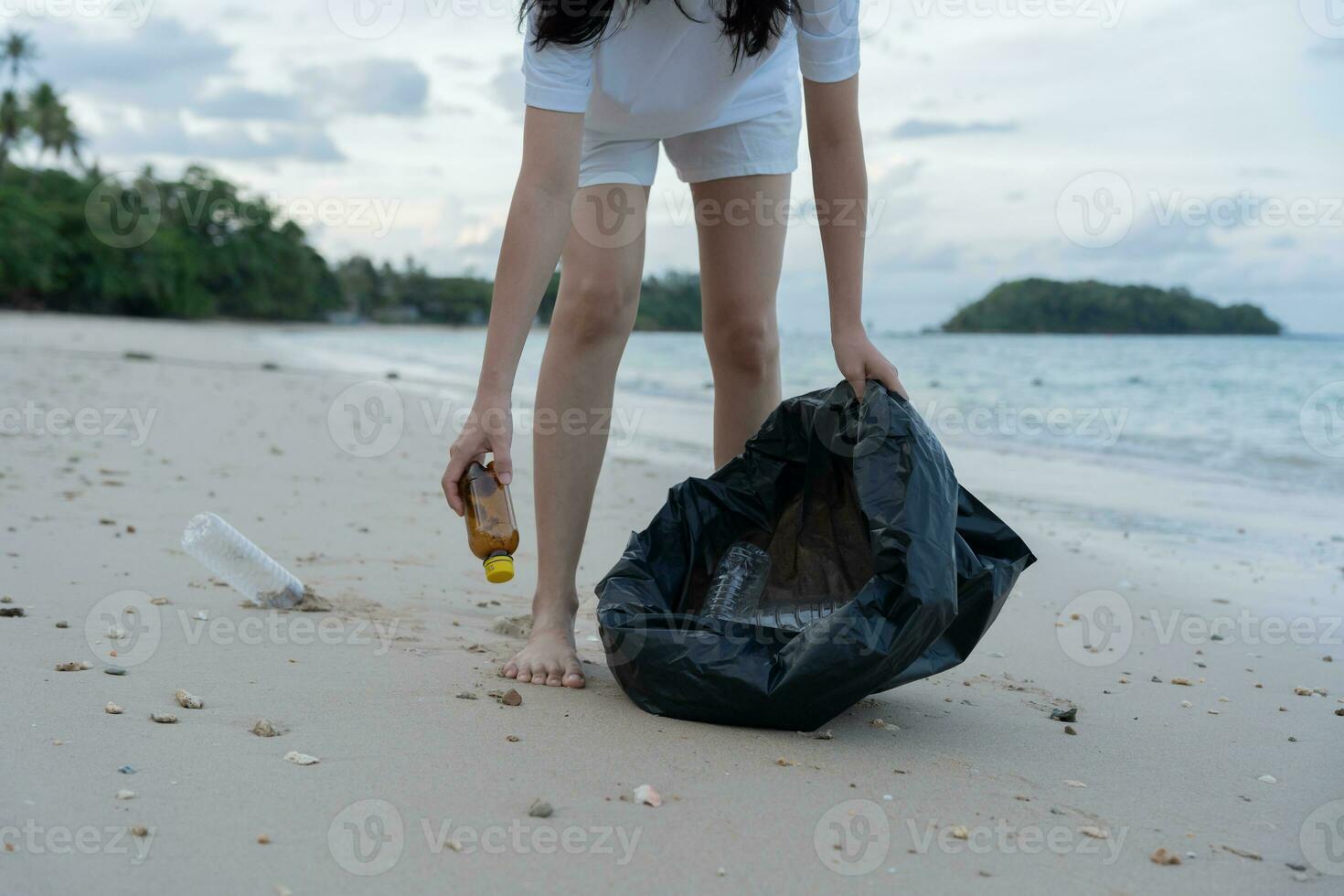 Save water. Volunteer pick up trash garbage at the beach and plastic bottles are difficult decompose prevent harm aquatic life. Earth, Environment, Greening planet, reduce global warming, Save world photo