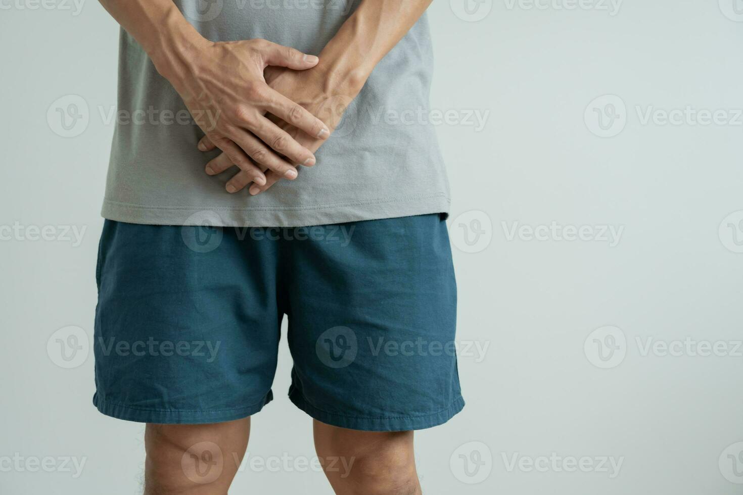 Man hold hand in front of private parts feeling discomfort from disease and inflammation. Venereal, testicular cancer. bladder problems, erectile dysfunction, premature ejaculation, prostate cancer photo