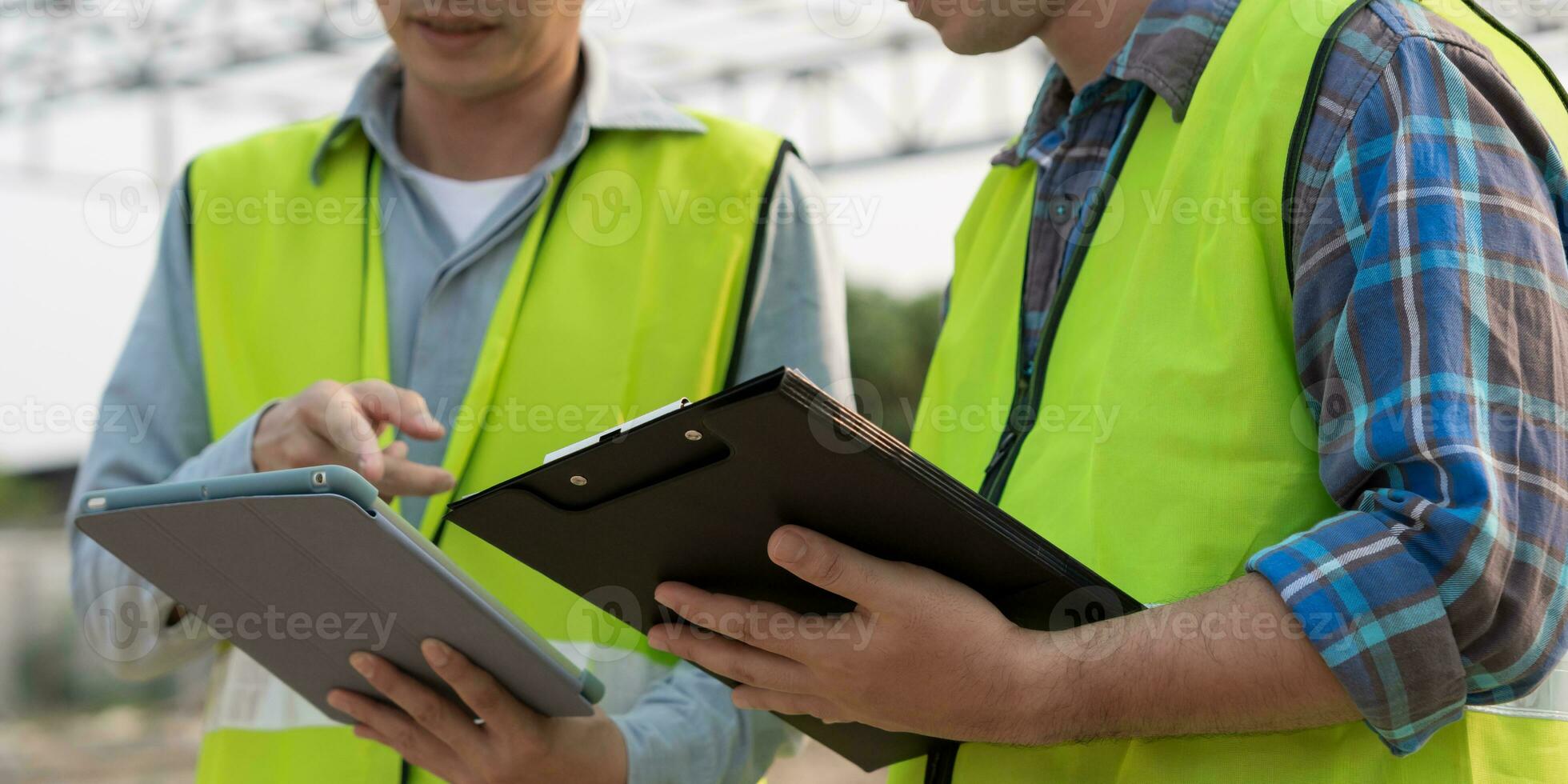 inspector or engineer is inspecting construction and quality assurance new house using a tablet. Engineers or architects or contactor work to build the house before handing it over to the homeowner photo