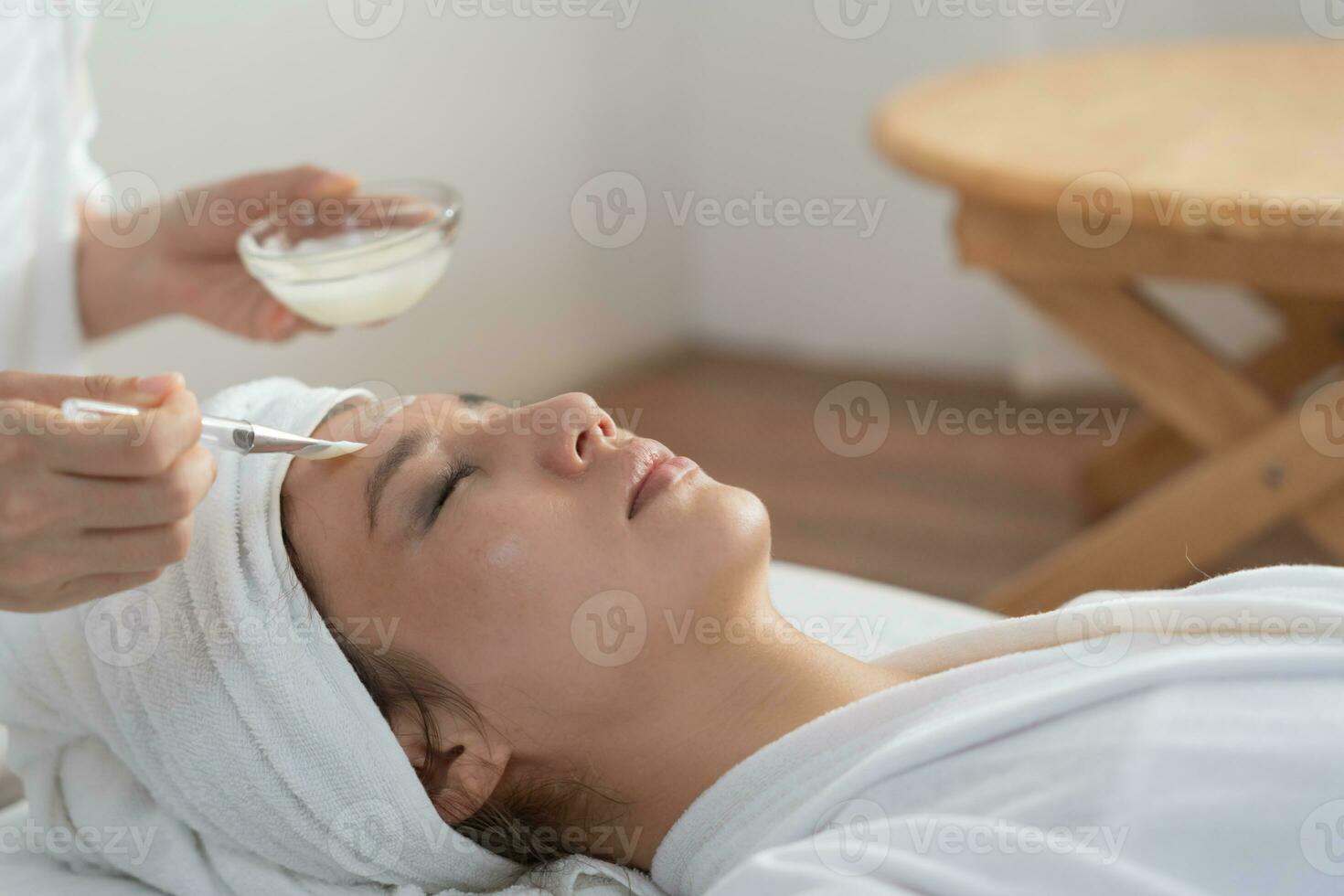 Beautiful woman receive spa and treatment skin of face. face of a healthy woman apply cream. Advertisement for skin cream, anti-wrinkle, baby face, whitening, moisturizer, tighten pores serum photo
