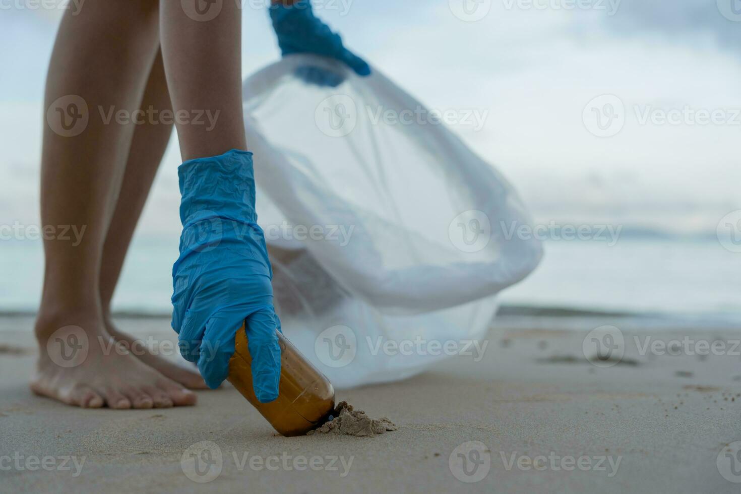 Save ocean. Volunteer pick up trash garbage at the beach and plastic bottles are difficult decompose prevent harm aquatic life. Earth, Environment, Greening planet, reduce global warming, Save world photo