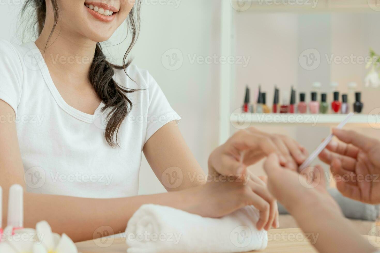 Woman receive care service by professional Beautician Manicure at spa centre. Nail beauty salon use nail file for Glazing treatment. manicurist make nail customer to beautiful. body care spa treatment photo