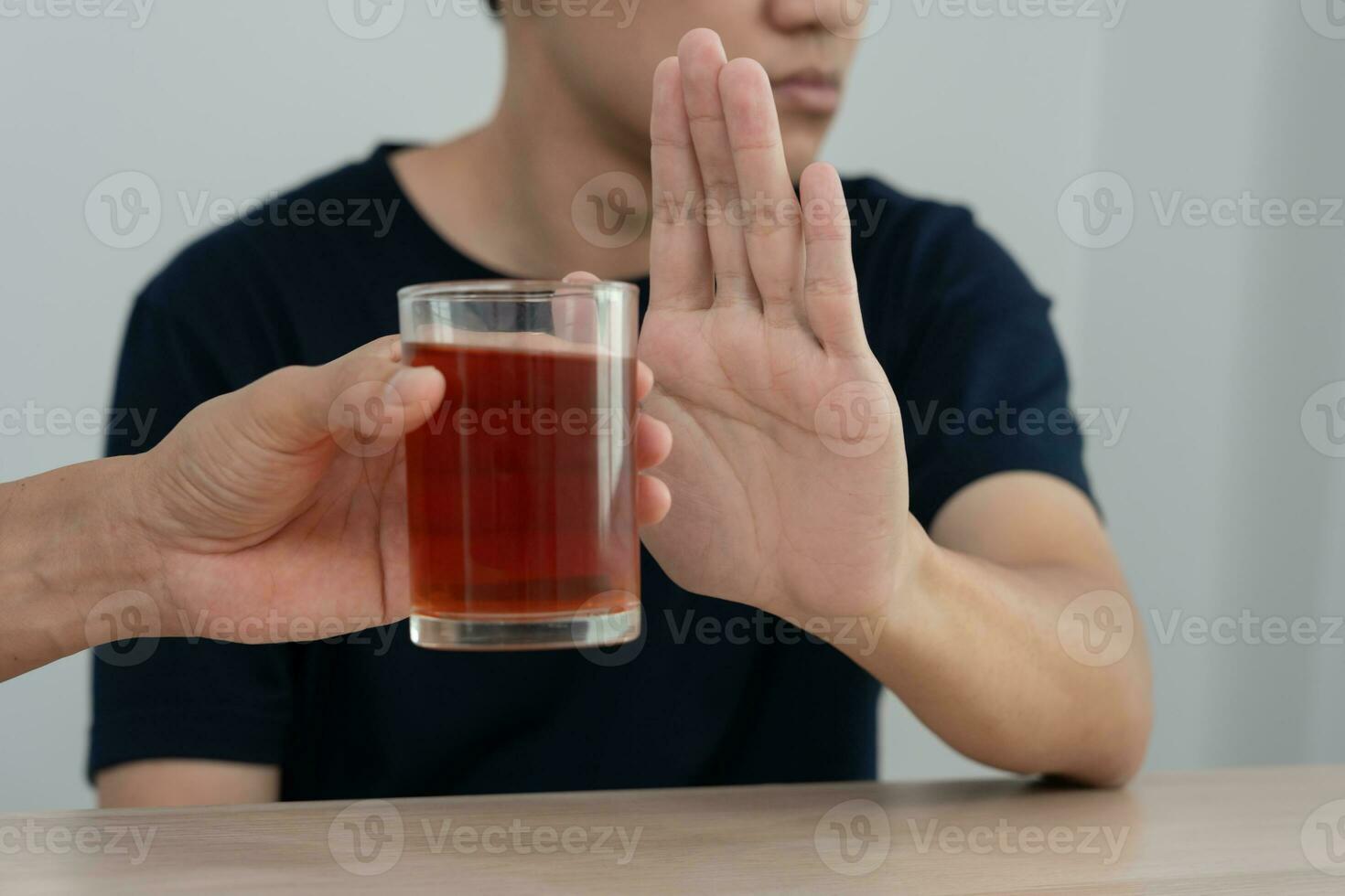 man refuses say no and avoid to drink an alcohol whiskey , stopping hand sign male, alcoholism treatment, alcohol addiction, quit booze, Stop Drinking Alcohol. Refuse Glass liquor, unhealthy, reject photo