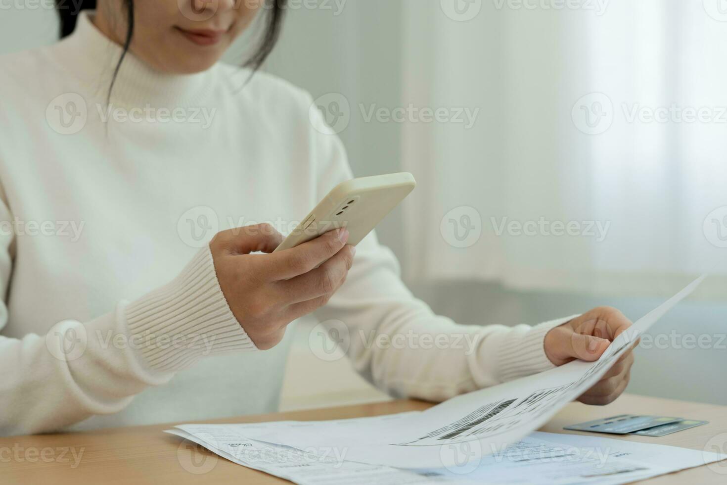Modern woman use phone to scan barcode or QR codes to pay credit card bill after receive document invoice. payment, receive, paying electricity, digital payments without money, technology, scanning photo