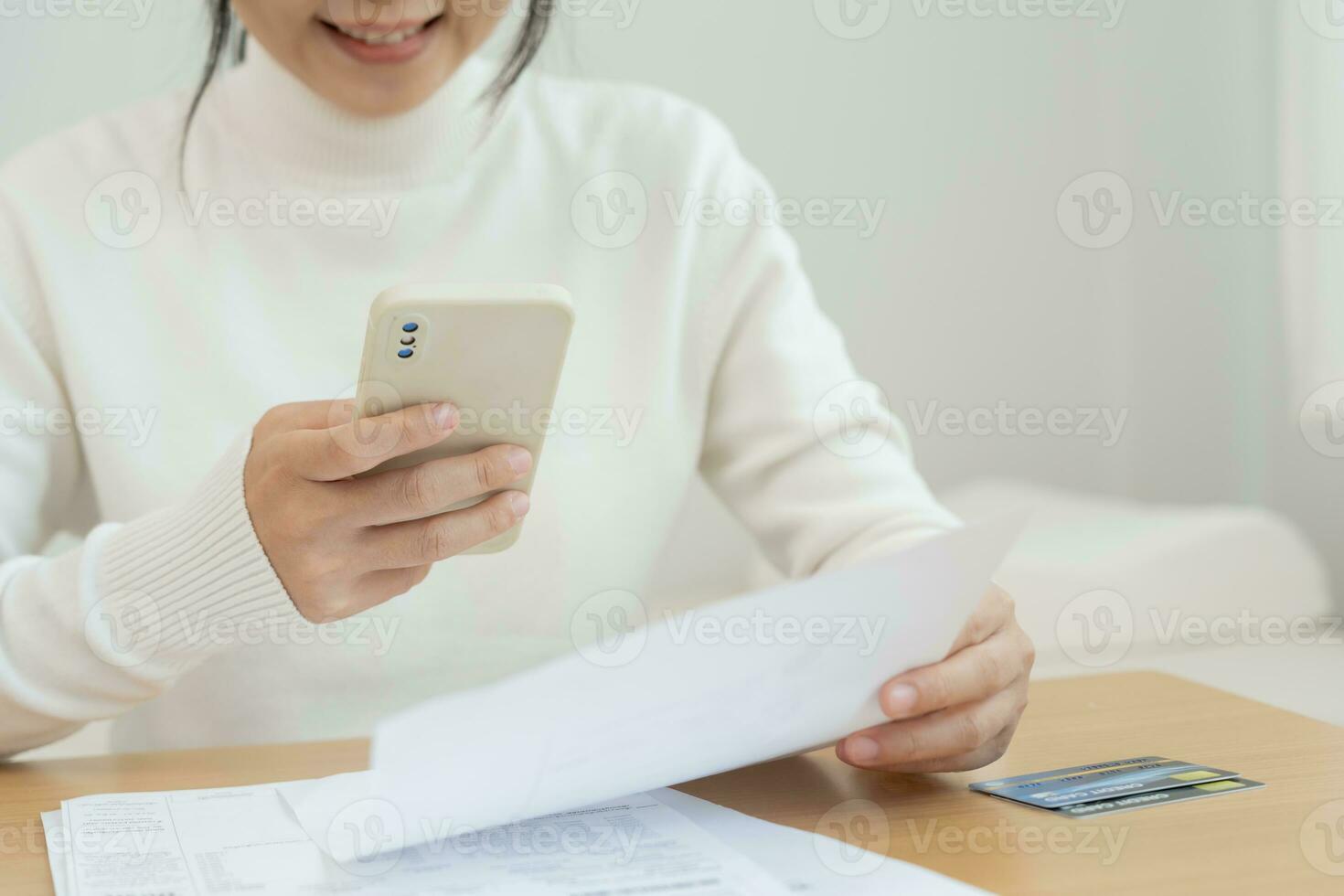 Modern woman use phone to scan barcode or QR codes to pay credit card bill after receive document invoice. payment, receive, paying electricity, digital payments without money, technology, scanning photo