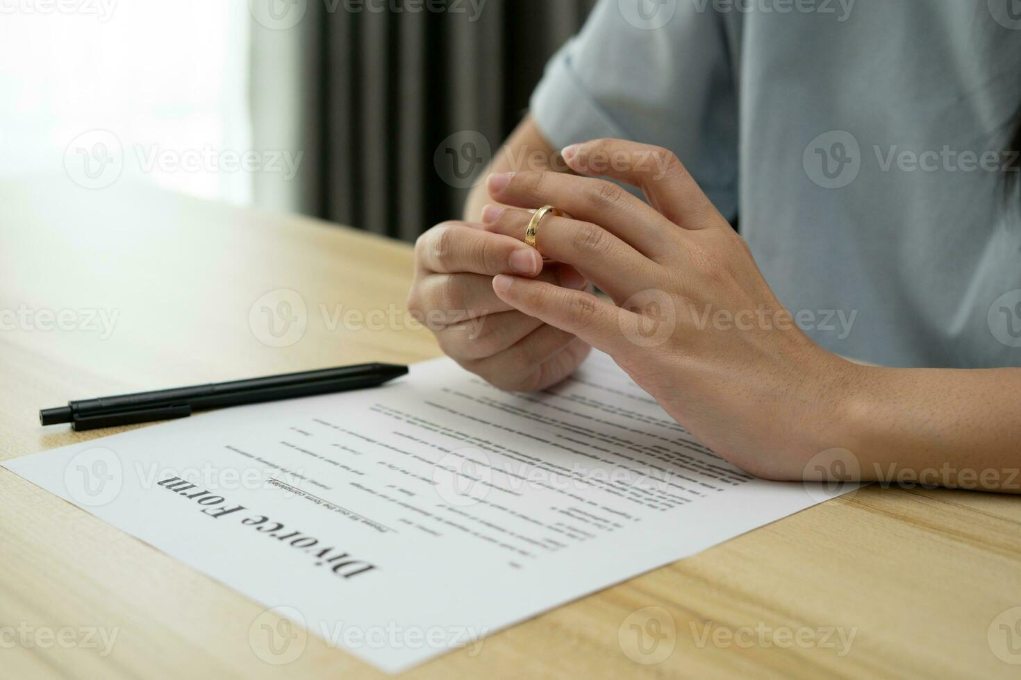 Divorce. Woman remove married ring and sign Divorce form. Couples desperate and disappointed after marriage. wife sad, upset and frustrated after quarrels conflict. distrust, love problems photo