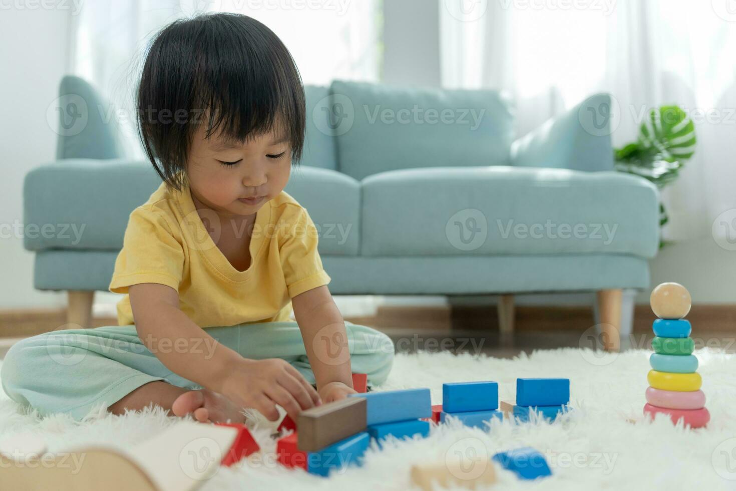 Happy Asian child playing and learning toy blocks. children are very happy and excited at home. child have a great time playing, activities, development, attention deficit hyperactivity disorder photo