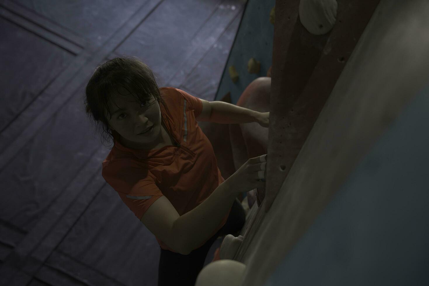 woman climbing on wall training in gym, active sporty female practicing rock climbing on artificial rock in extreme sport, bouldering, wall, climber is training, rock climbing in the city, strong photo