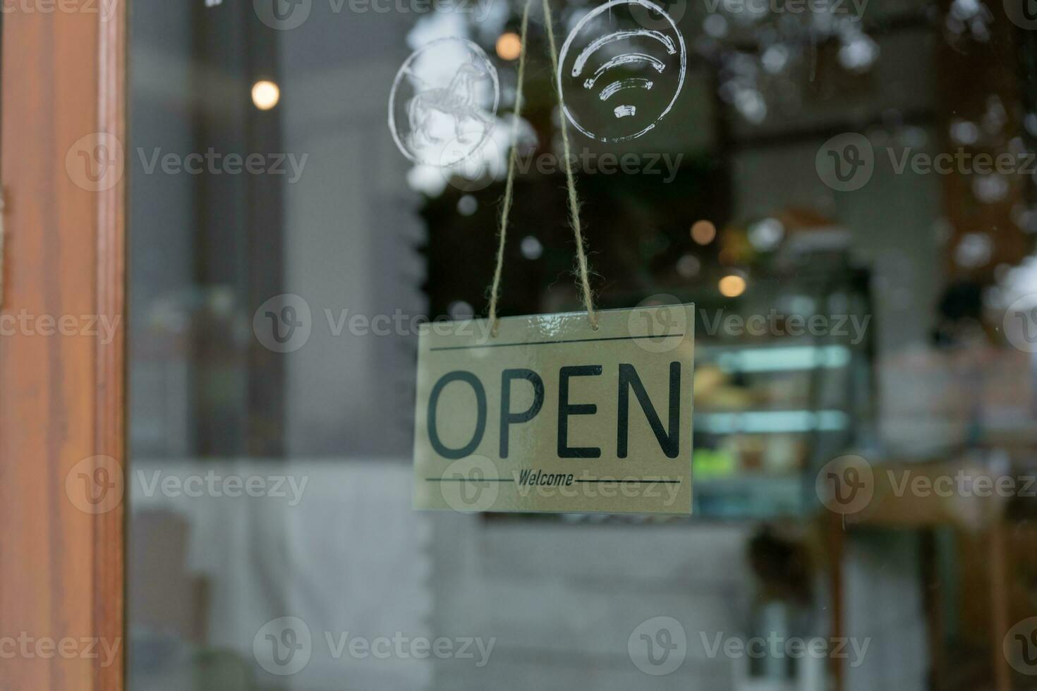 owner show sign open on the first day of business. guarantees safety, cleanliness, open the coffee shop. open for New normal. Small business, welcome, restaurant, home made, family photo