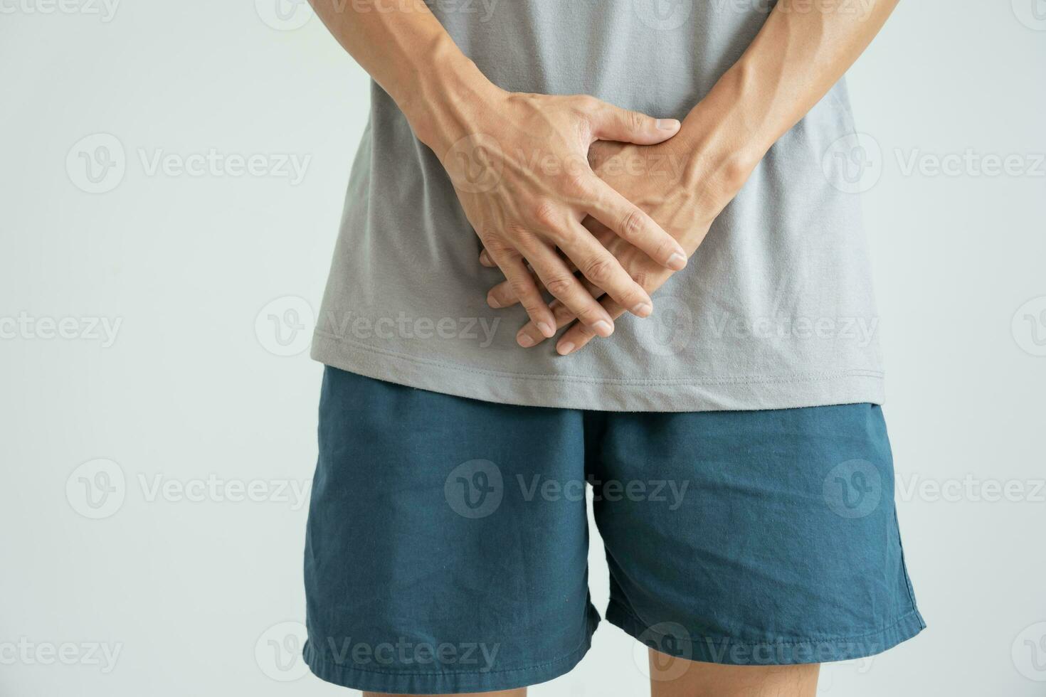 Man hold hand in front of private parts feeling discomfort from disease and inflammation. Venereal, testicular cancer. bladder problems, erectile dysfunction, premature ejaculation, prostate cancer photo