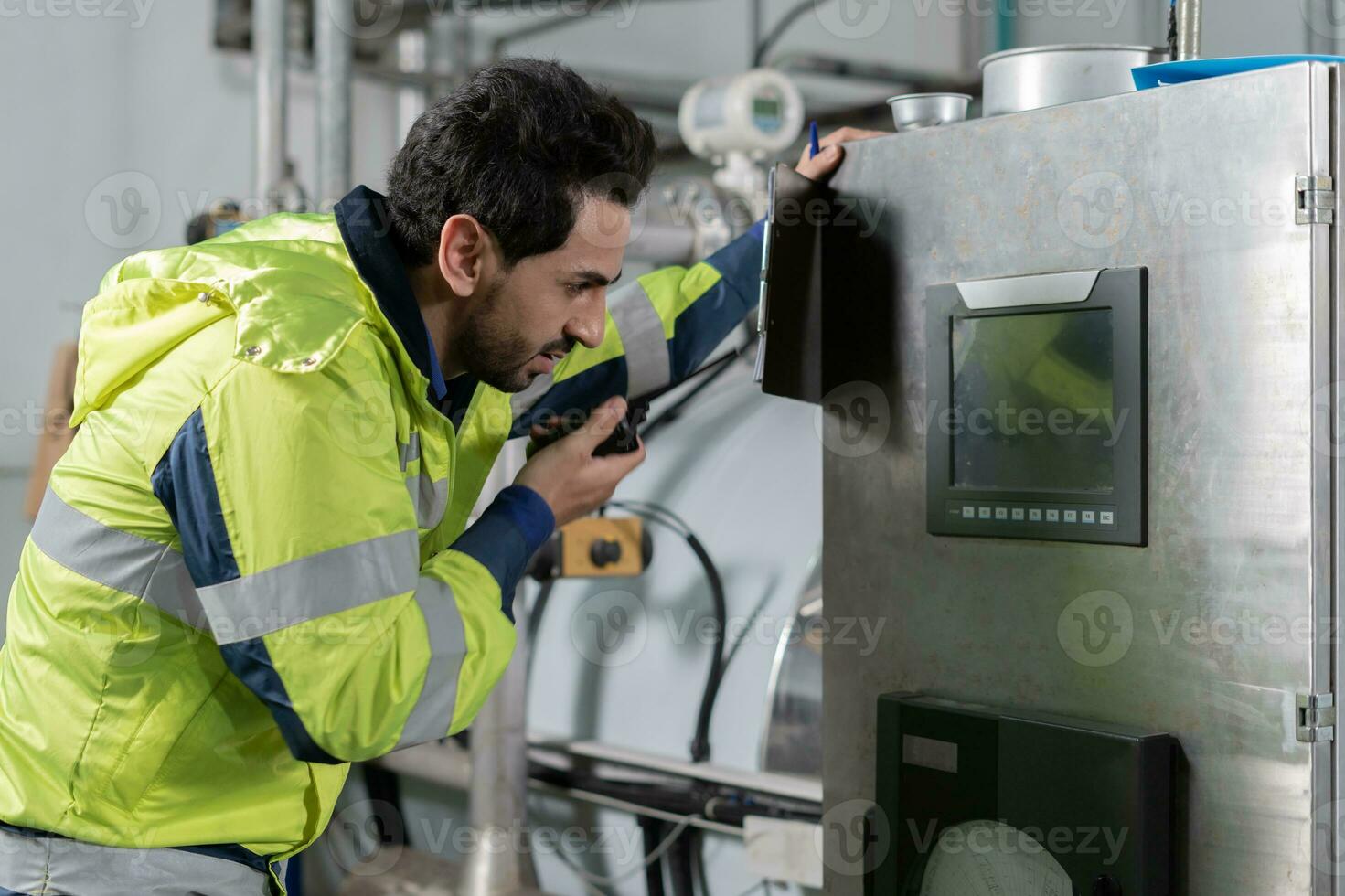 Engineers or factory managers wearing safety helmet inspect the machines in the production line. The inspector opened the machine to test the system to meet the standard. machine maintenance photo