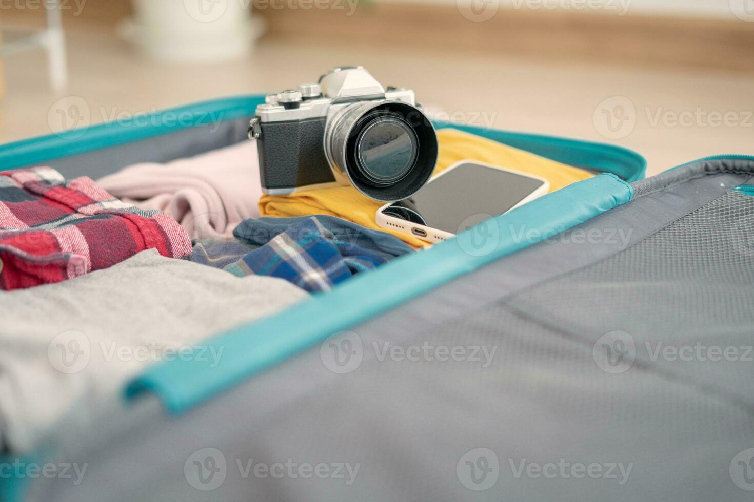 Traveler. preparing a camera for travel and photography. women are prepare clothes and personal belongings. Pack your luggage before travel. holiday, vacation time, long weekend, summer photo