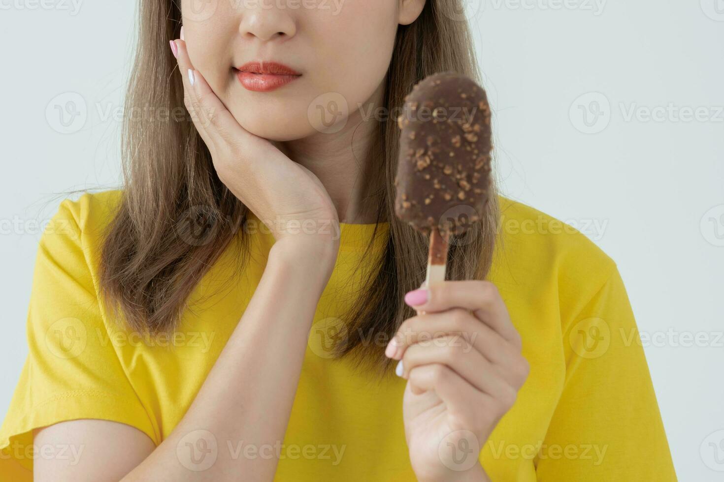 Asian woman feel sensitive teeth after eating ice cream, female suffer
