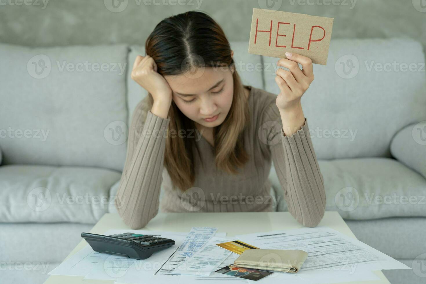Stressed and headache asian woman with large bills or invoices no money to pay to expenses and credit card debt. shortage, Financial problems, mortgage, loan, bankruptcy, bankrupt, poor, empty wallet photo