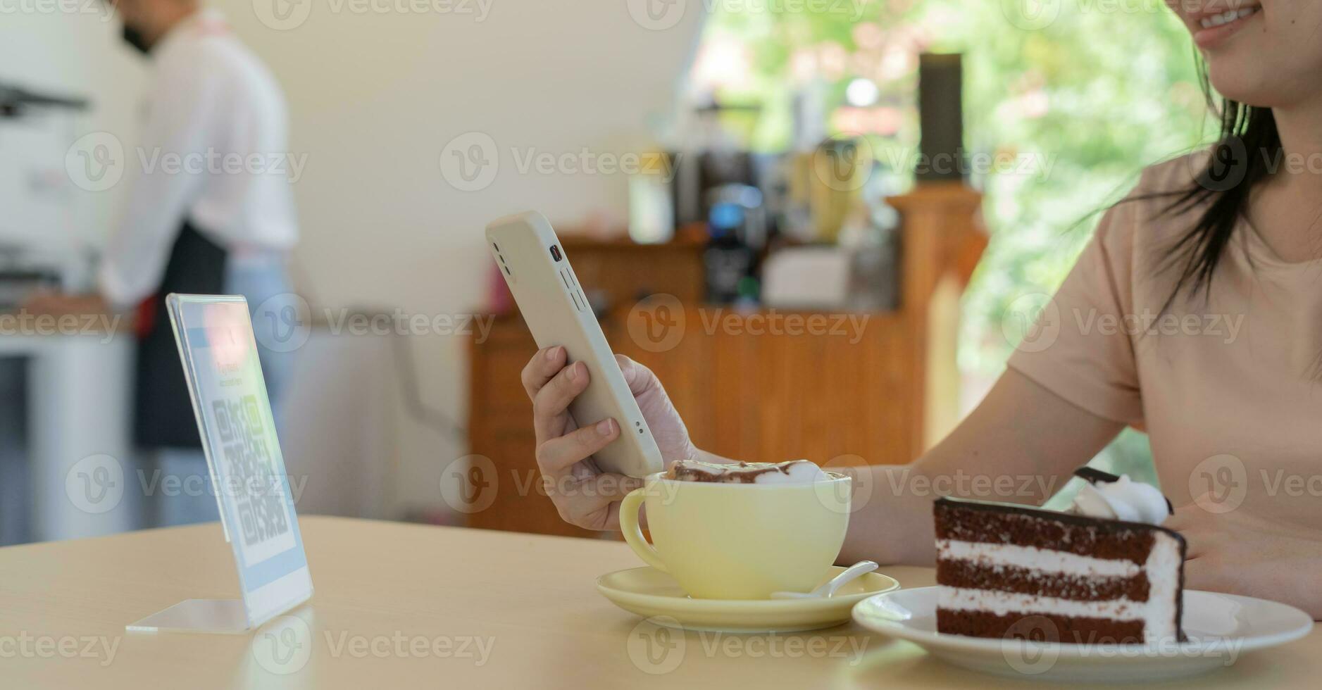 Woman use smartphone to scan QR code to pay in cafe restaurant with a digital payment without cash. Choose menu and order accumulate discount. E wallet, technology, pay online, credit card, bank app. photo