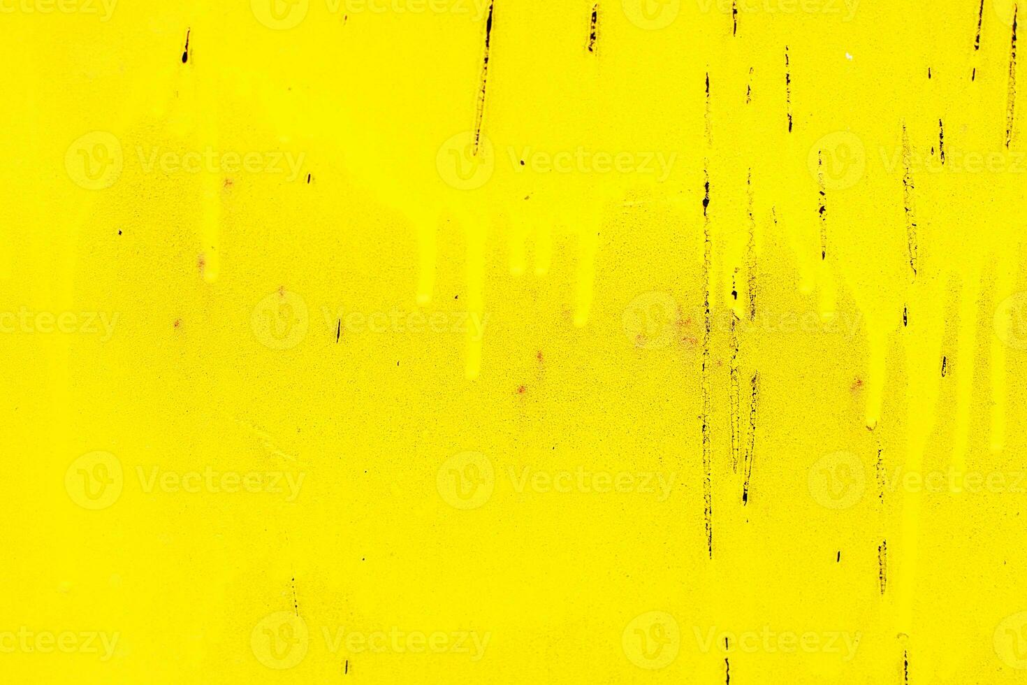 Rusty yellow metal abstract background. Texture of an old plate with dripping stained cracked paint photo