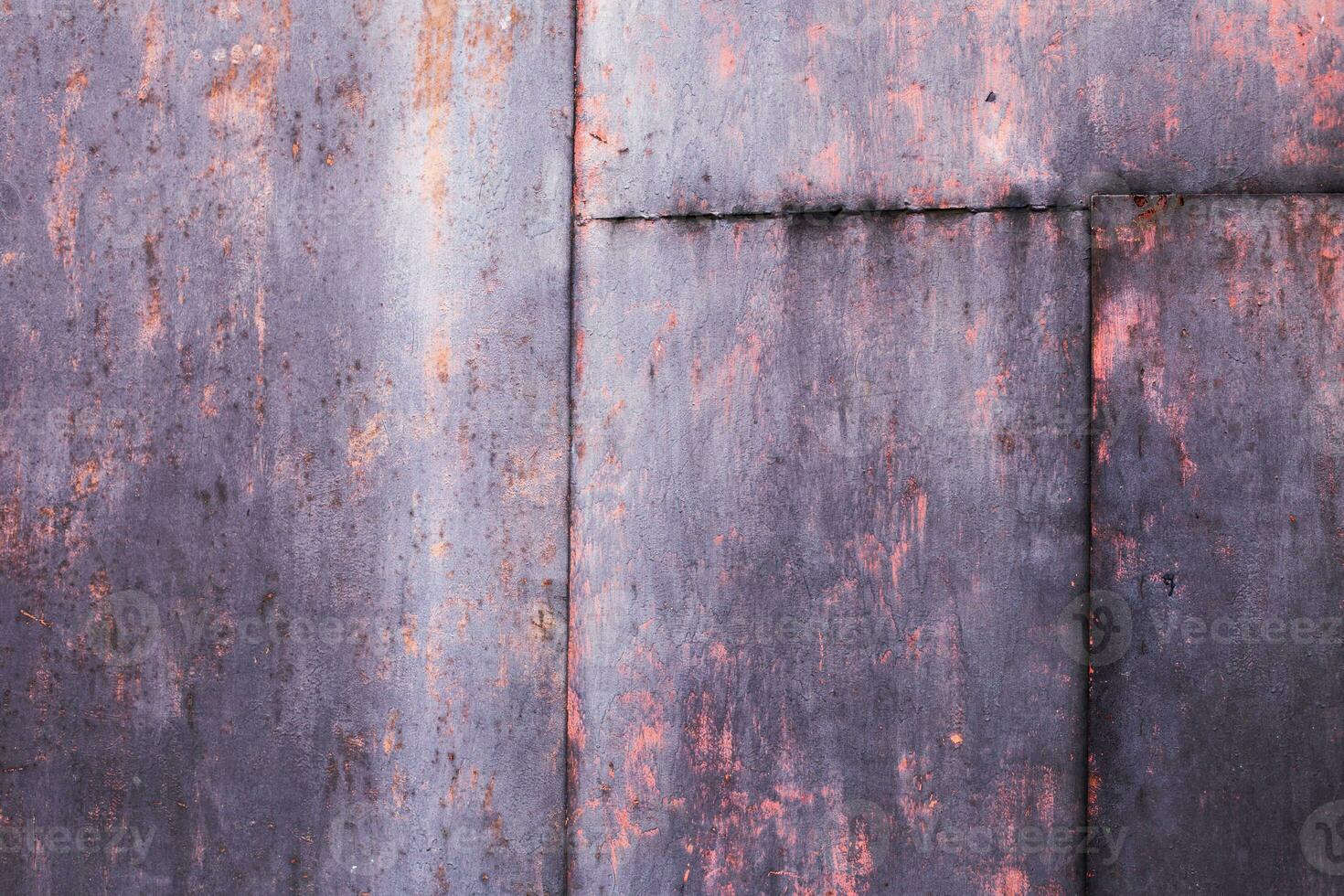 Rusty pink metal abstract background. Texture of an old plate with dripping stained cracked paint photo