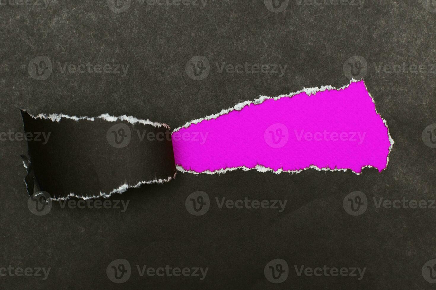 curl of torn black paper on pink background. advertising and sale concept. copy space photo