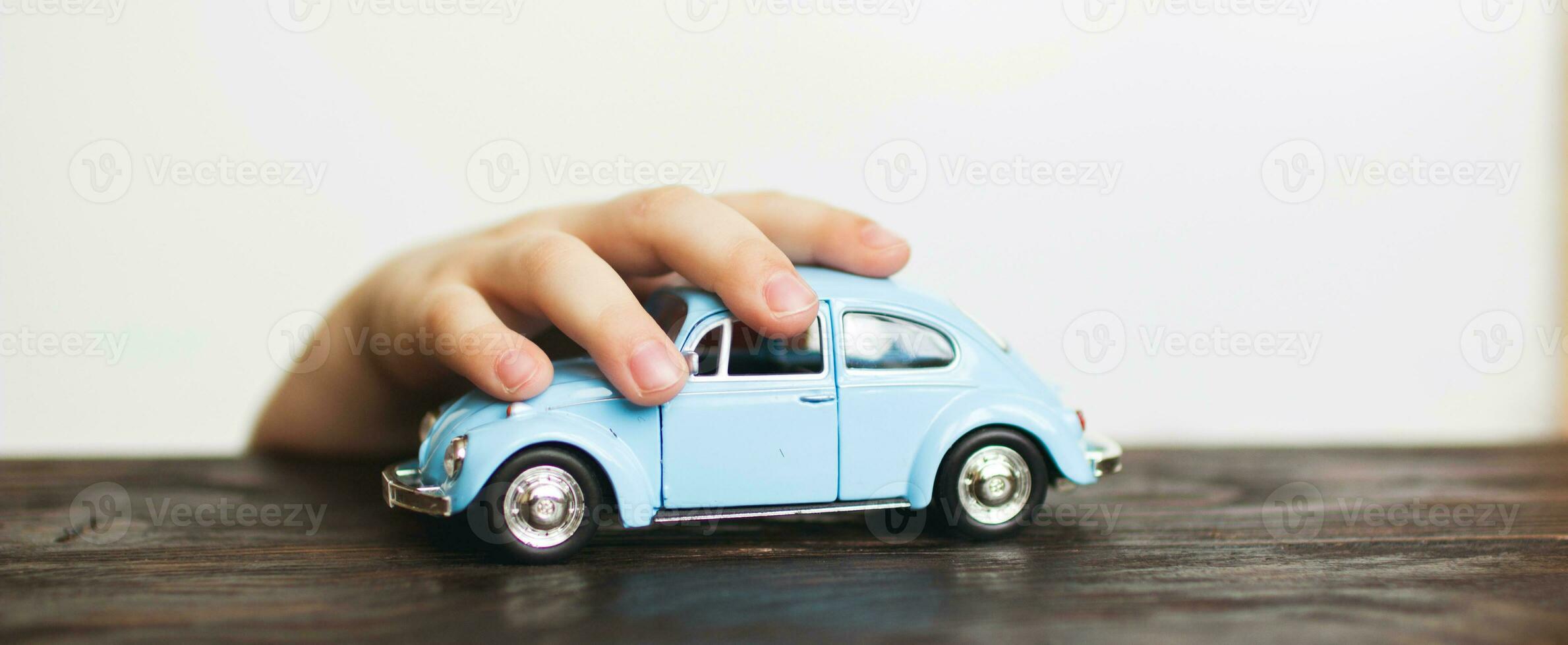 child playing with the car close on a white background photo