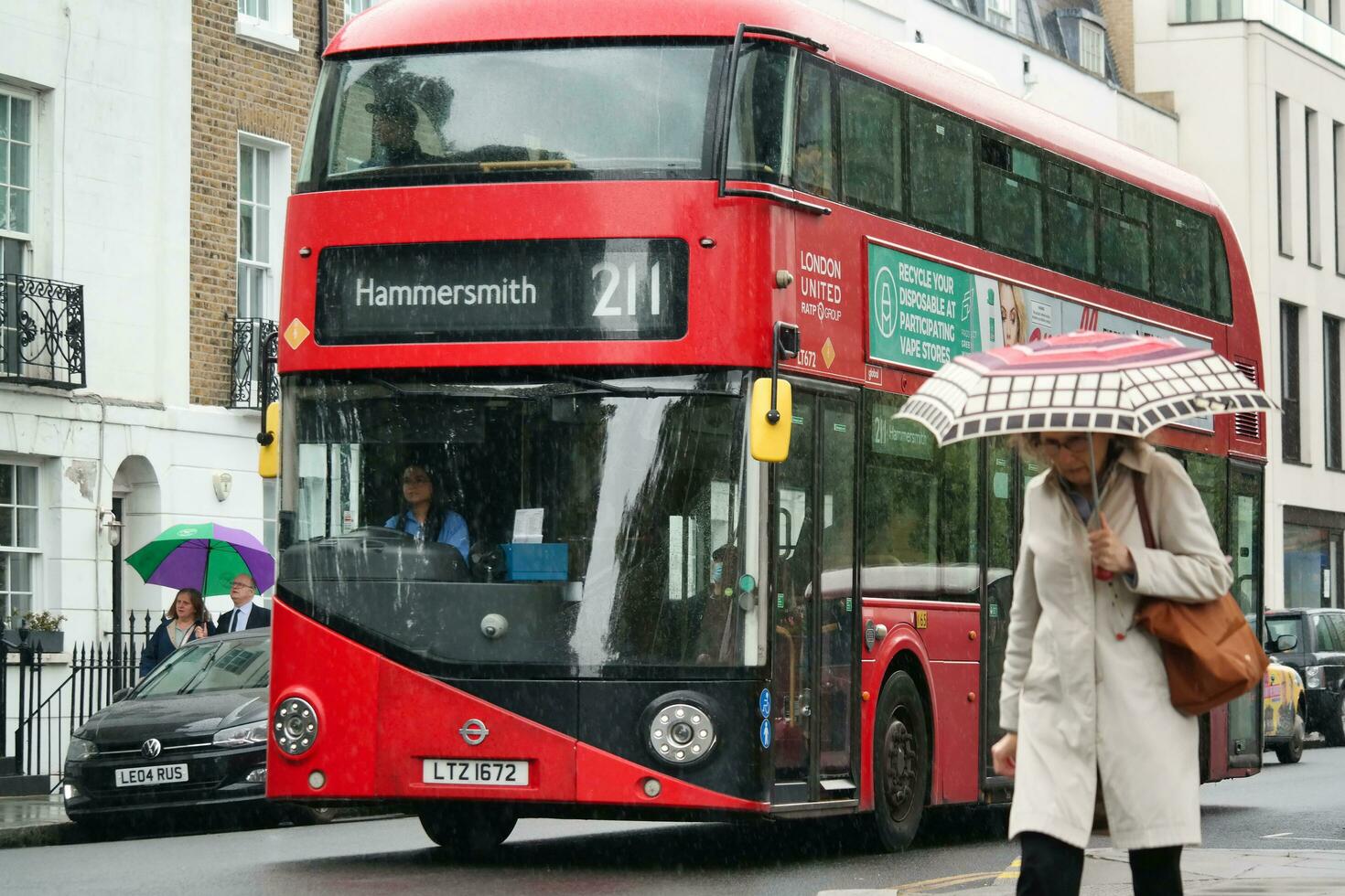 Gorgeous Low Angle view of Bus Service and British Traffic at Central London City of England UK. Image Captured on August 2nd, 2023 During Cloudy and Rainy Day. photo