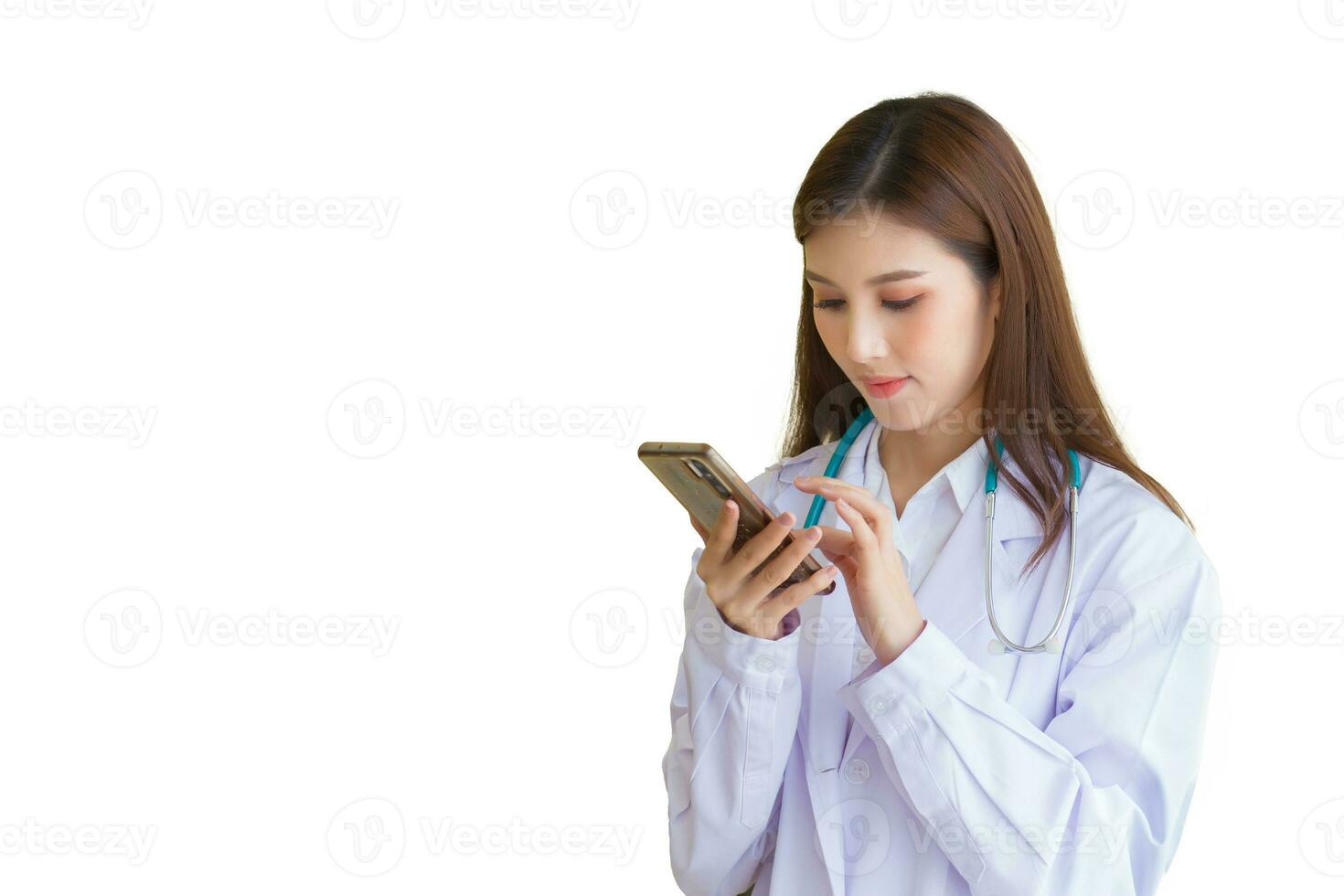 Professional young Asian woman doctor wearing white robe standing with using smart phone for examine report document of patient to plan next treatment in hospital photo