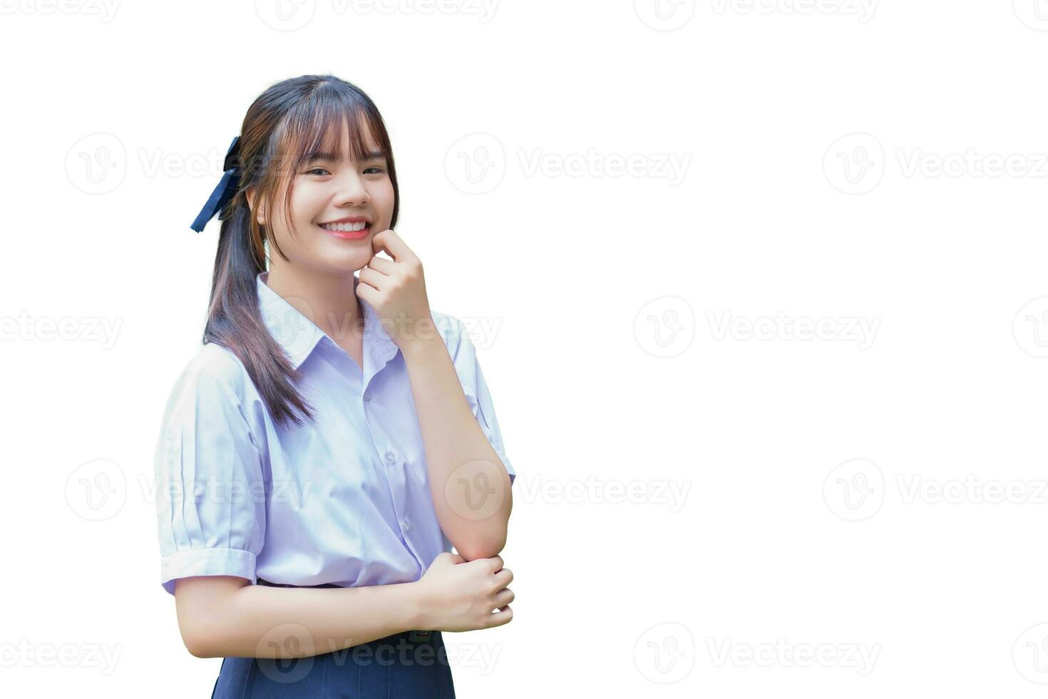 Beautiful Asian high school student girl in the school uniform with smiles confidently while she looks at the camera happily while isolated on white background photo