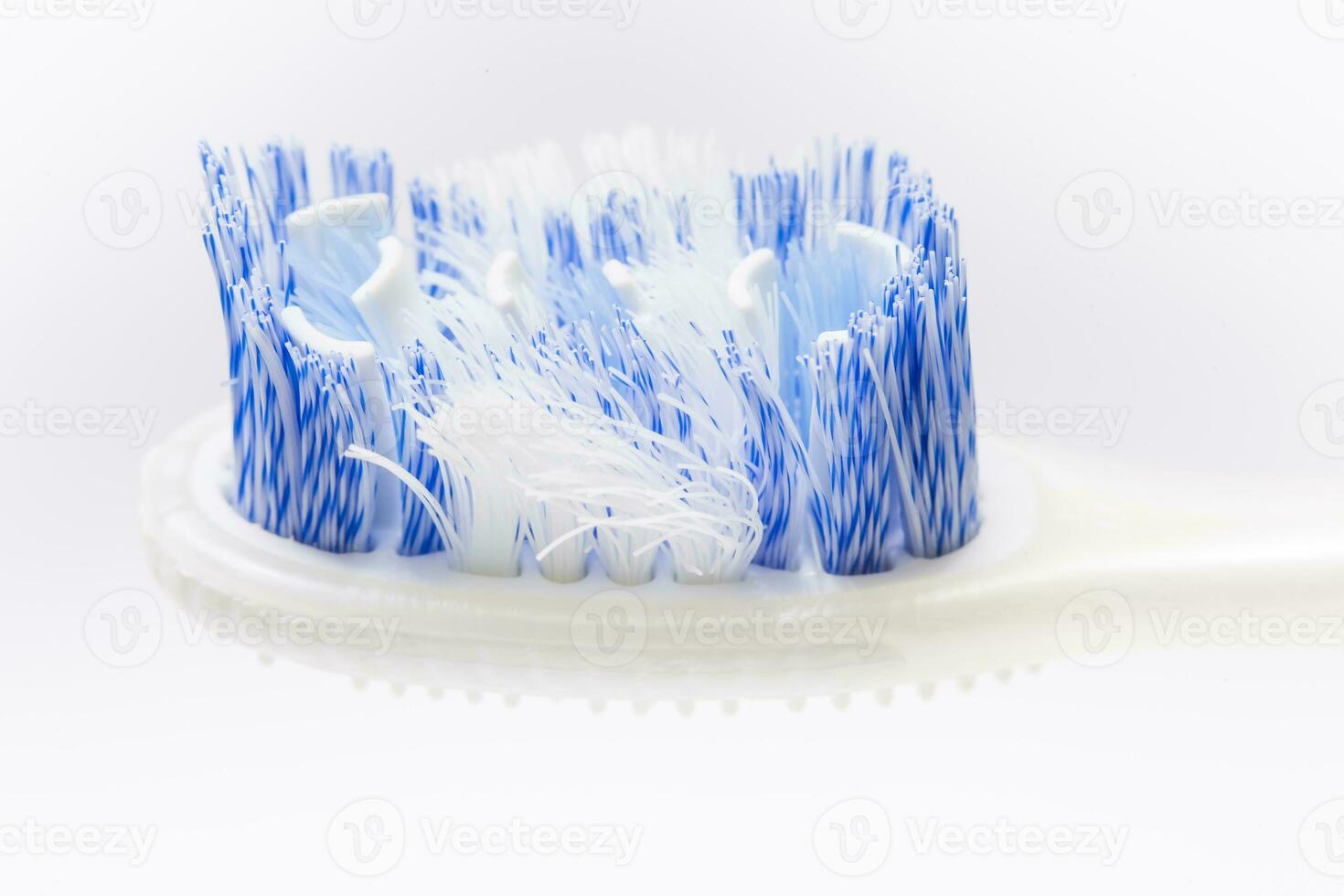 Closeup of an old toothbrush on white background. Oral health concept photo