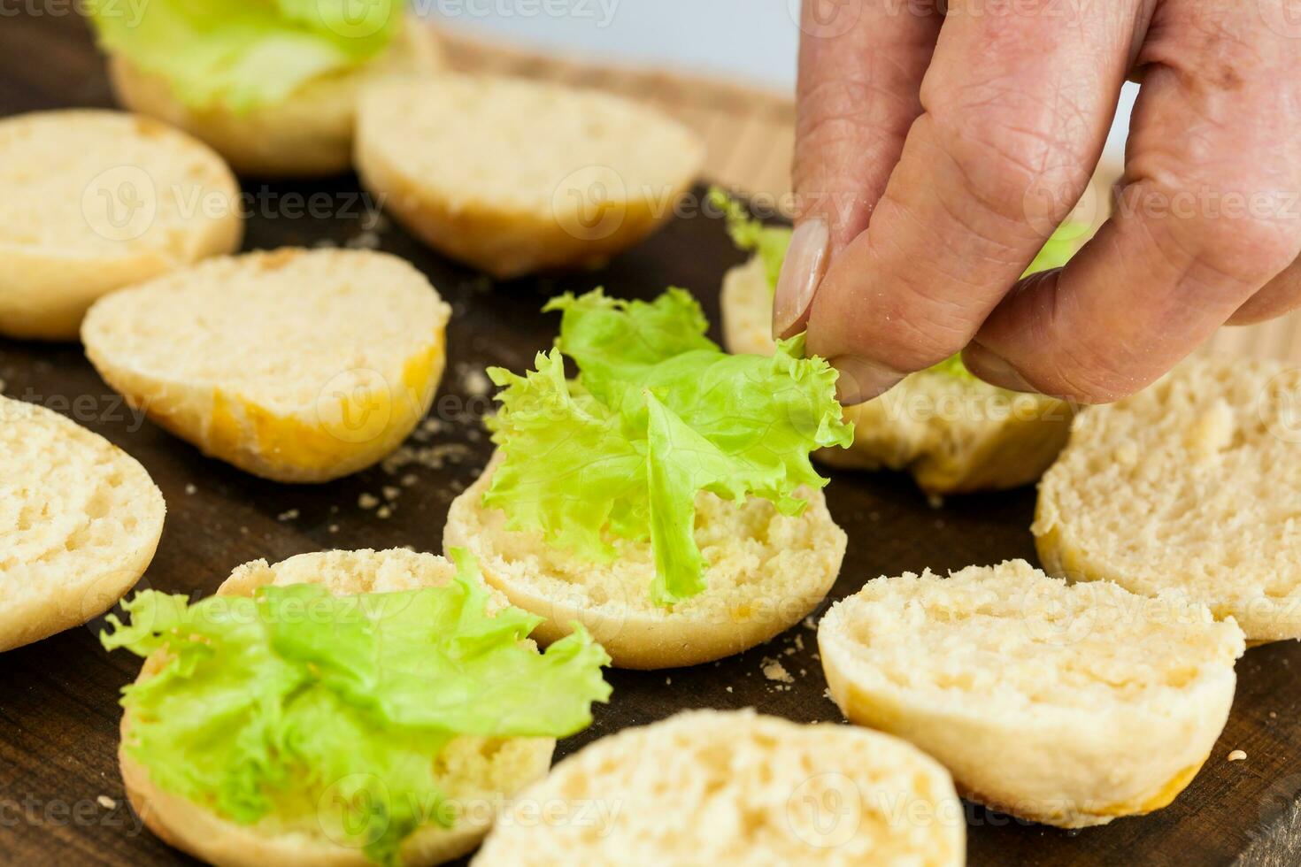 Step by step preparation of mini burgers. Homemade mini burgers for children or appetizers. Small hamburgers. Assembling burgers photo