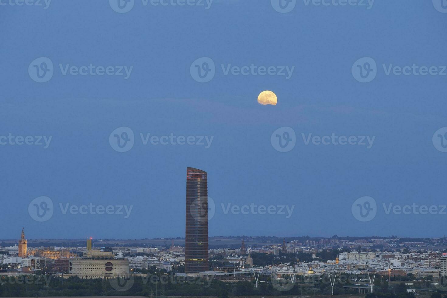 Seville's Nocturnal Splendo. Giralda and Sevilla Tower Bathed in Moonligh photo