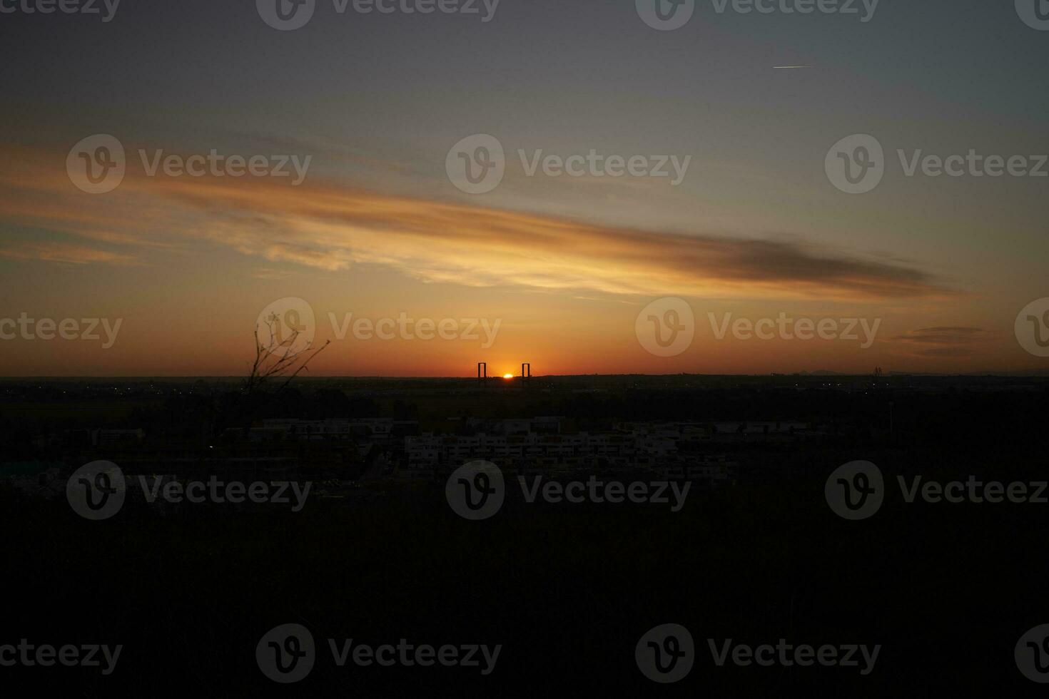 Seville's Glorious Sunrise. A Spectacular View of the Quinto Centenario Bridge and the City's Silhouette photo