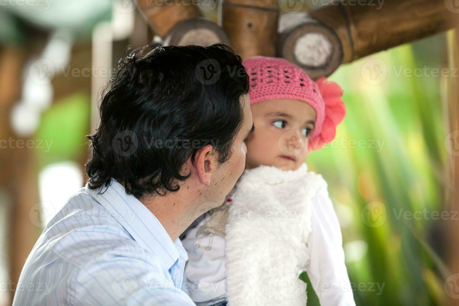 Young father having fun outdoors with his baby girl. Fatherhood concept. Happiness concept. Family concept photo