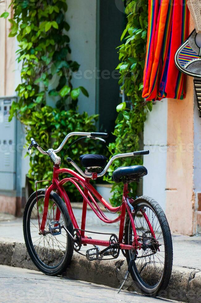 Bicycle parked at the beautiful streets of the walled city in Cartagena de Indias. Urban bicycle concept. Mobility concept photo