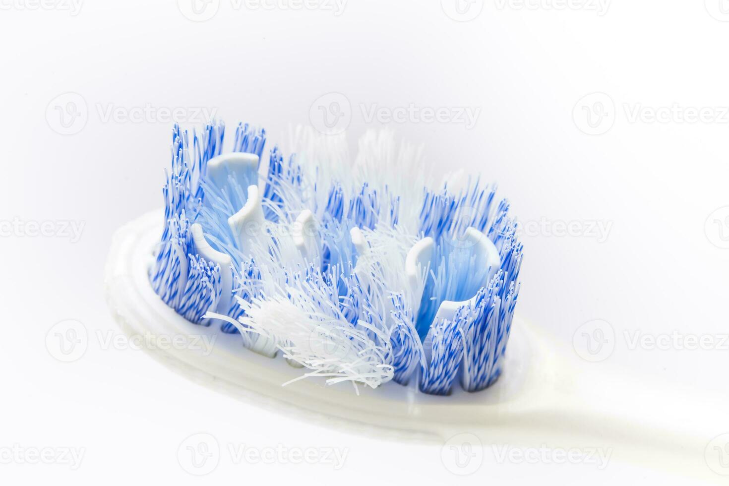 Closeup of an old toothbrush on white background. Oral health concept photo