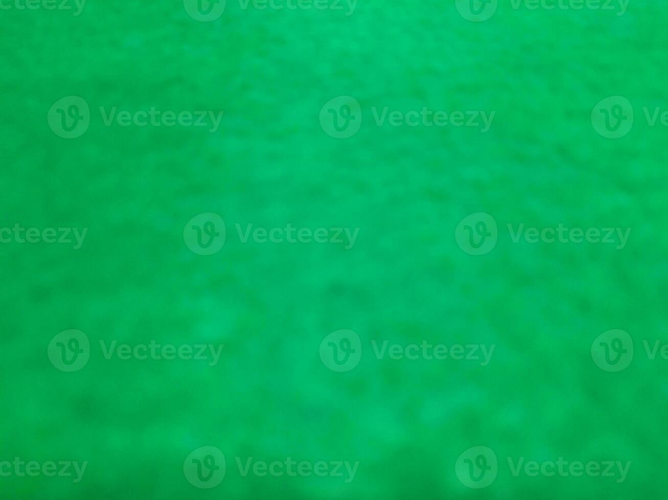 Defocused abstract carpet background in bright green color photo