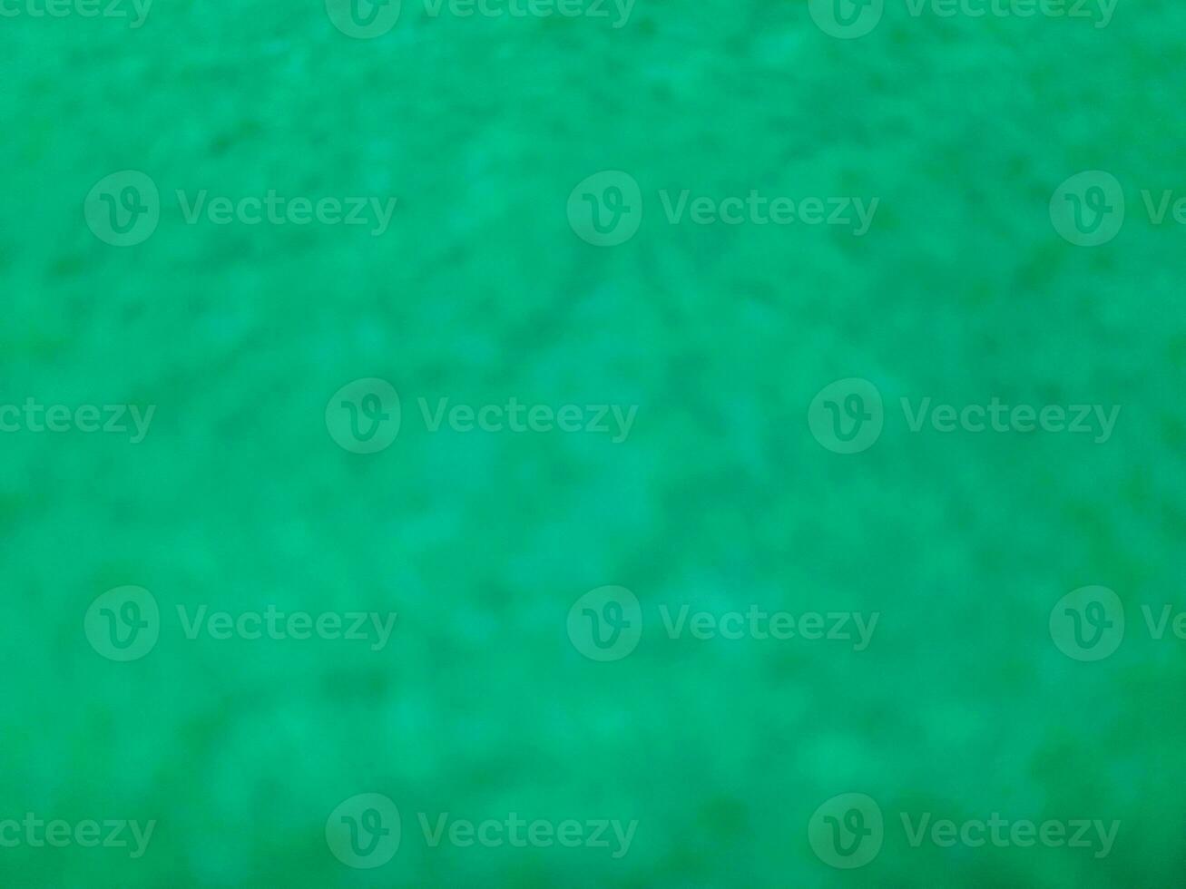 Defocused abstract carpet background in bright Tosca green color photo