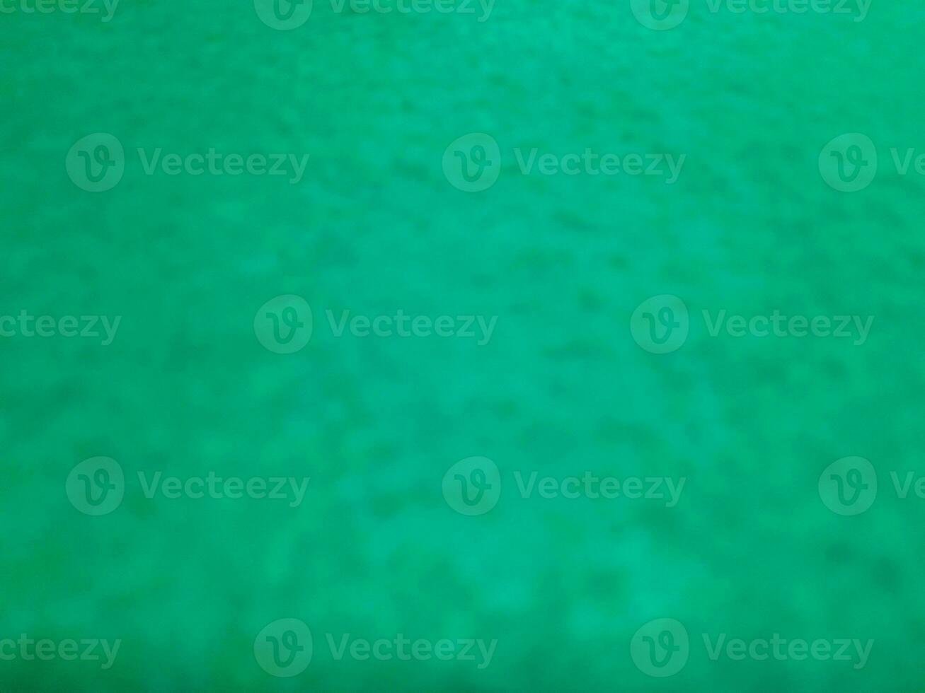 Defocused abstract carpet background in bright Tosca green color photo