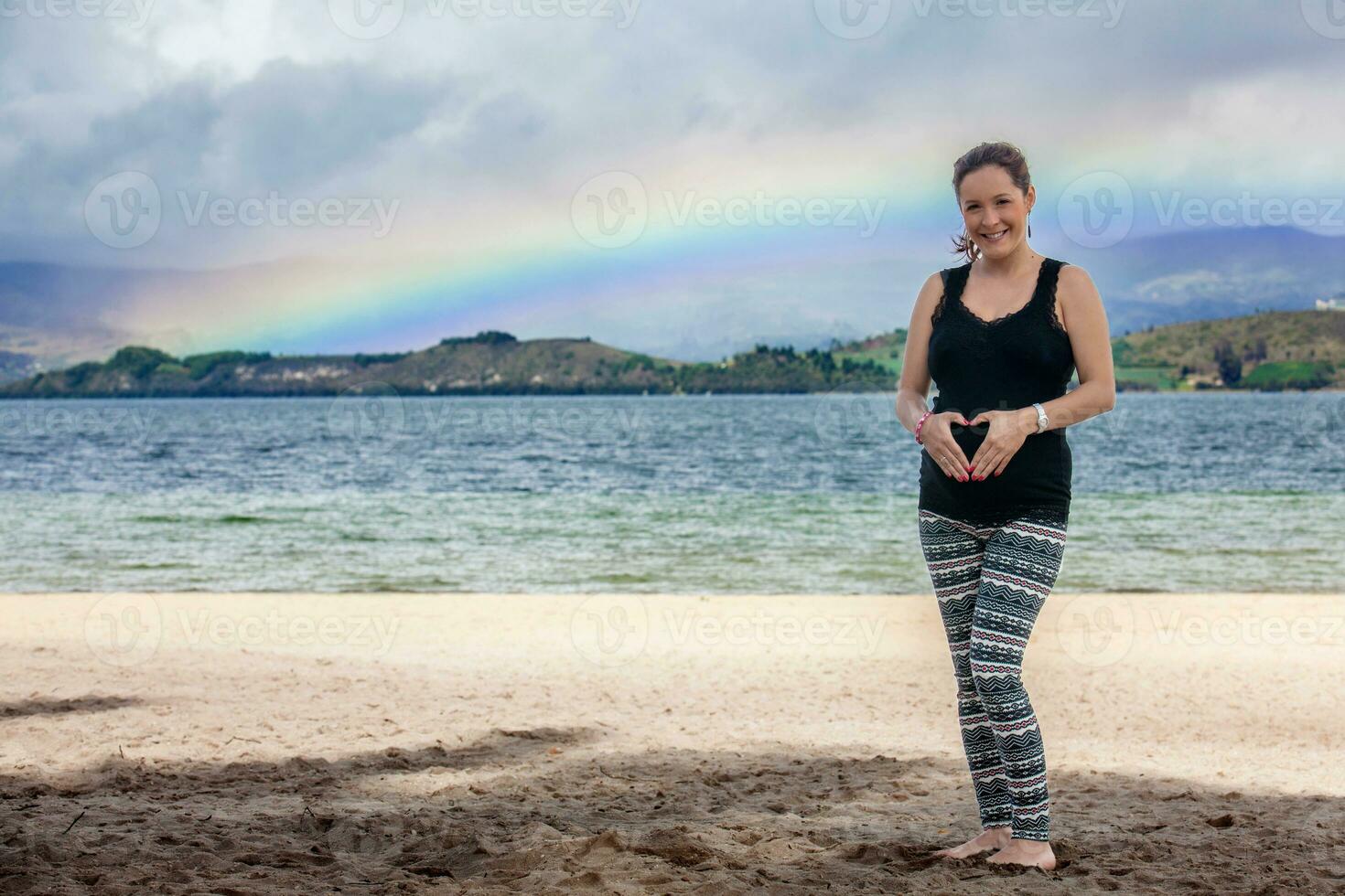 Portrait of a young woman waiting for her baby at the beautiful white beach of Lake Tota located in the department of Boyaca at 3,015 meters above sea level in Colombia photo