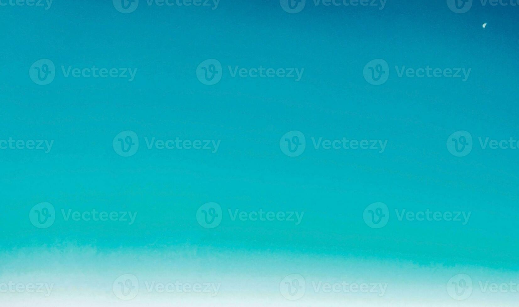 blue sky background with tiny clouds and the moon in the clear sky photo