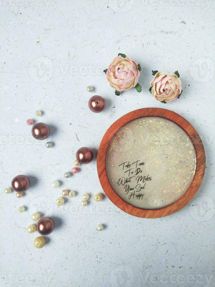 Handmade resin coaster with floral pattern on white background. Selective focus. photo