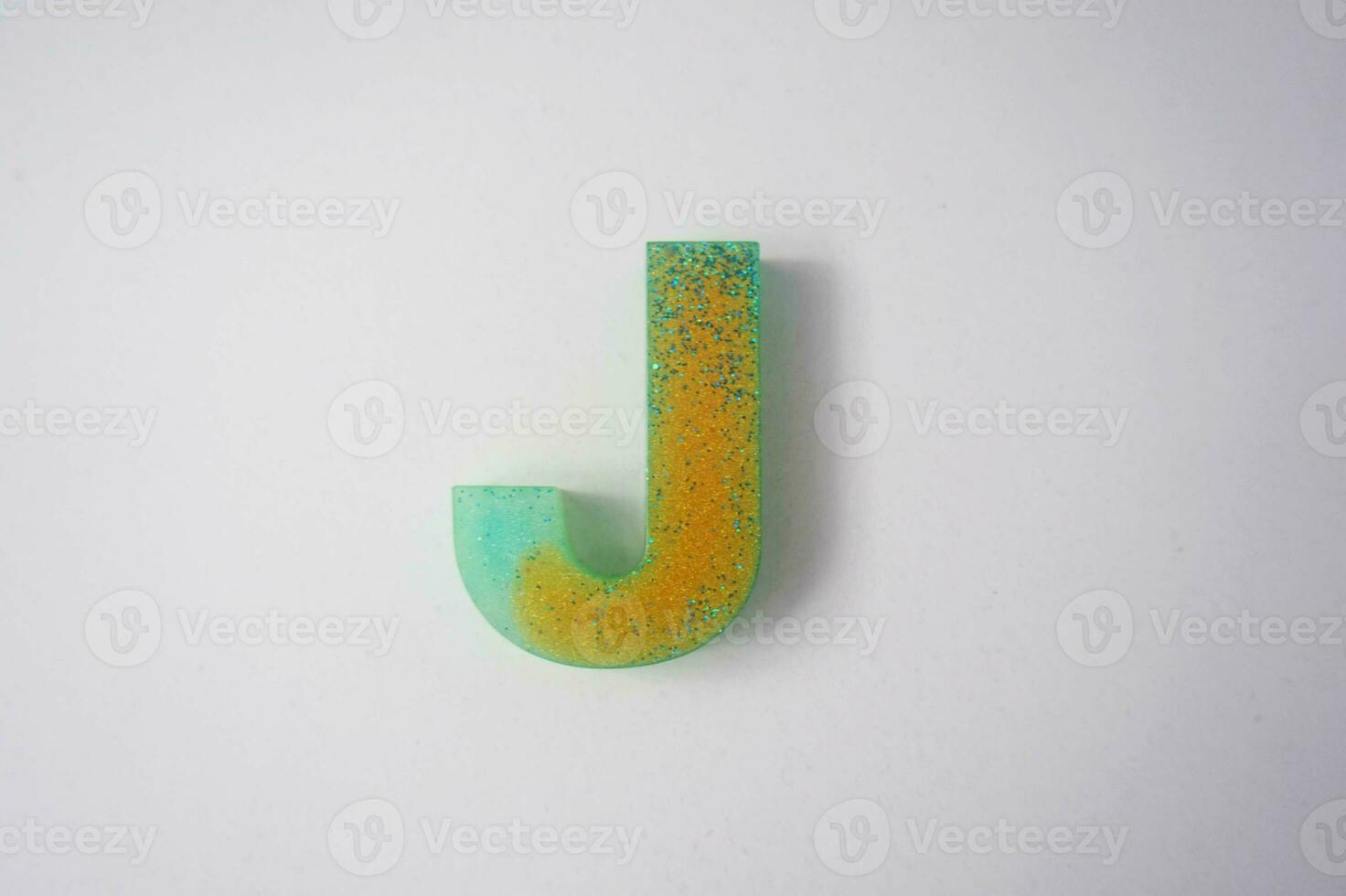Letter J of the English alphabet made of colored plasticine on a white background photo