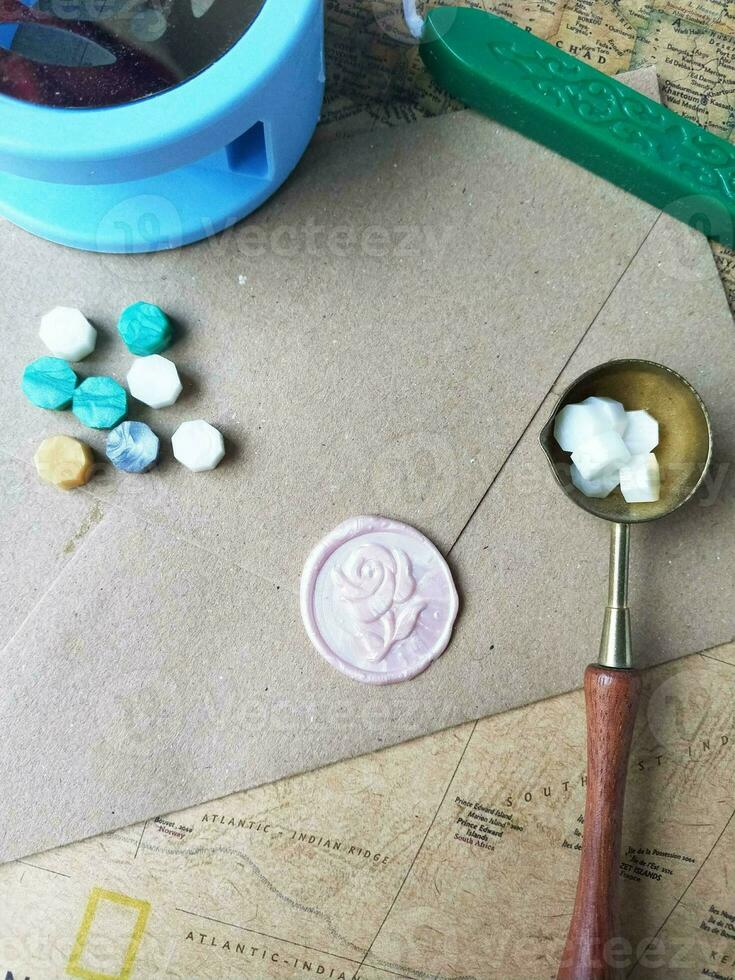 Old letter with wax seal and wax seal on old map background. photo