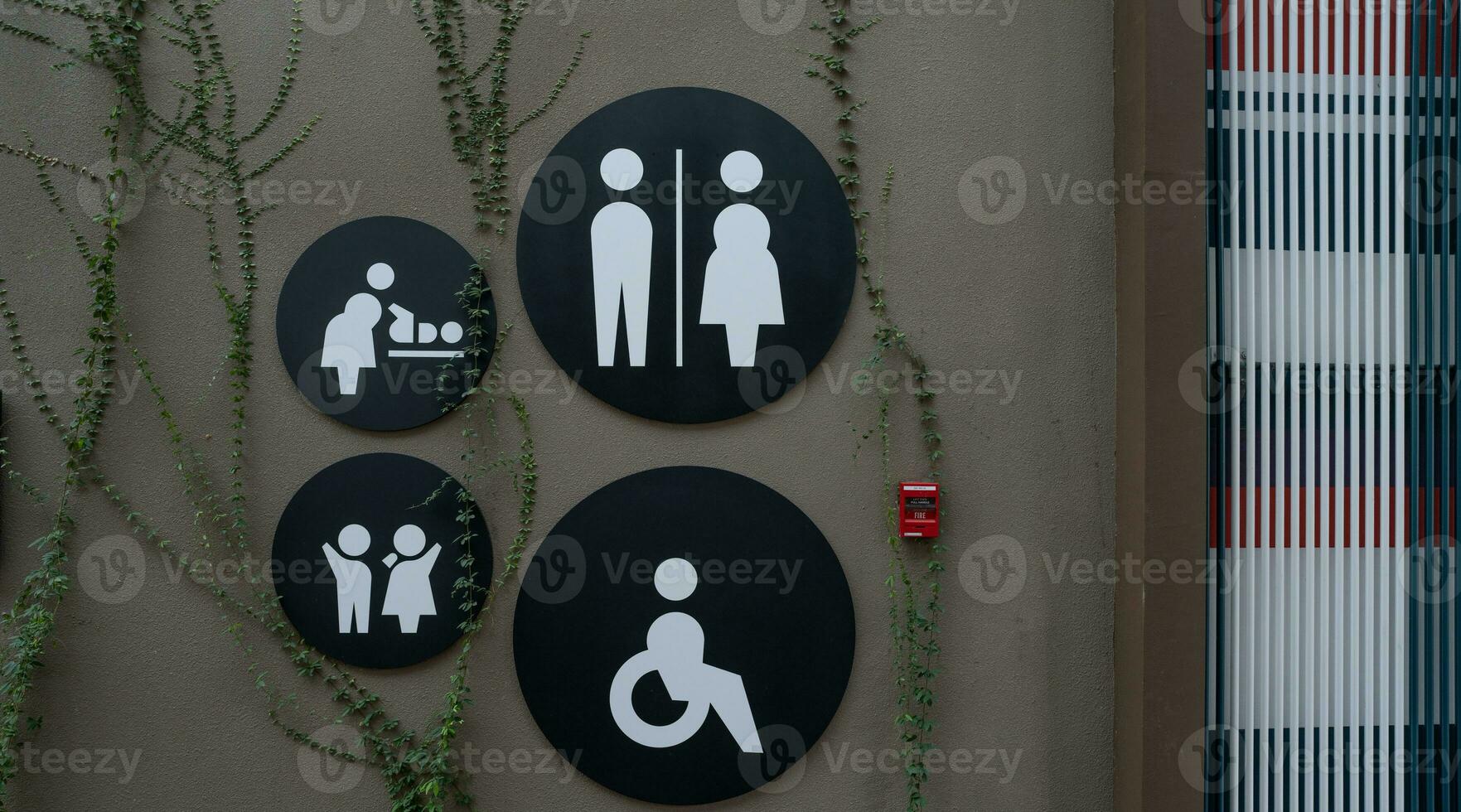 Public toilet sign. Woman, men, children, baby diaper changing, and disabled person toilet icon on restroom wall. Public restroom universal icon. Disabled access symbol. Latrine or WC. Washroom sign. photo