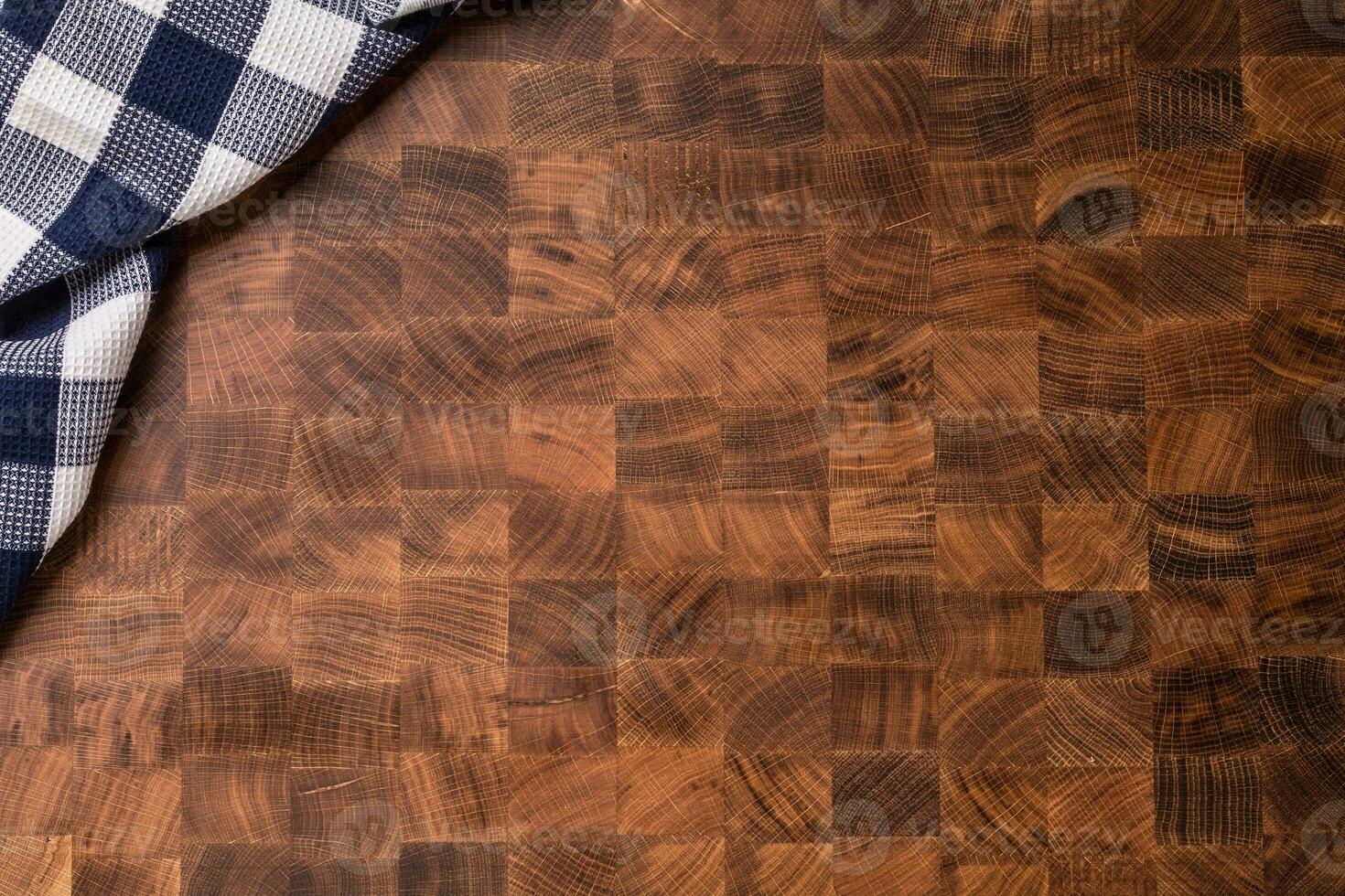 Top  of view checkered tablecloth on empty wooden butcher board photo