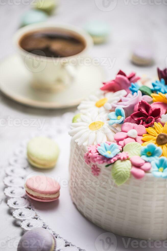 Cake from marzipan flowers macaroons and  black coffee. photo