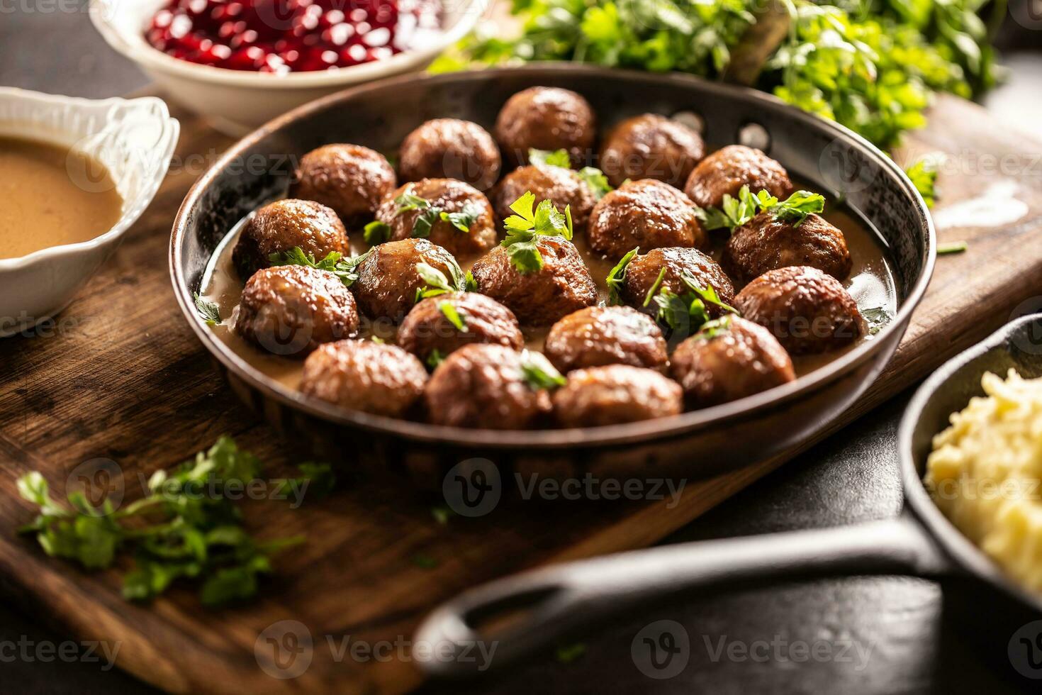 Swedish meatballs, kottbullar, in a pan topped with fresh parsley photo